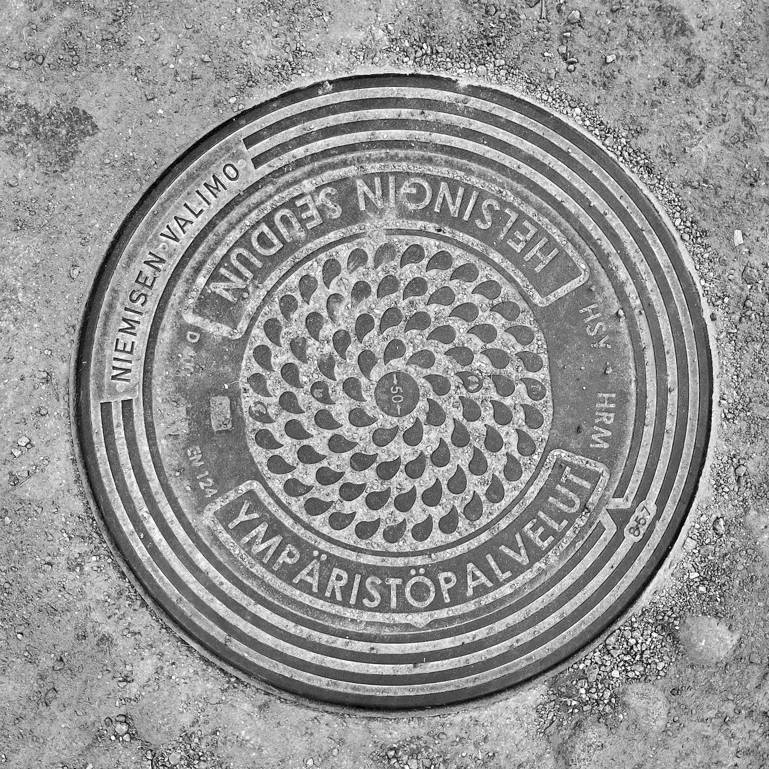black and white image of a utility cover
