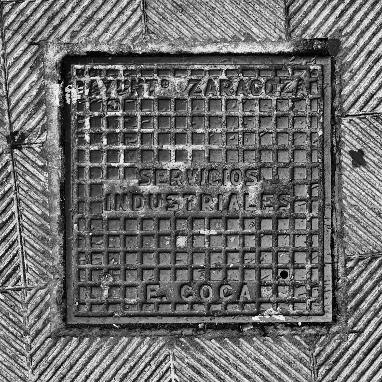 black and white image of a utility cover