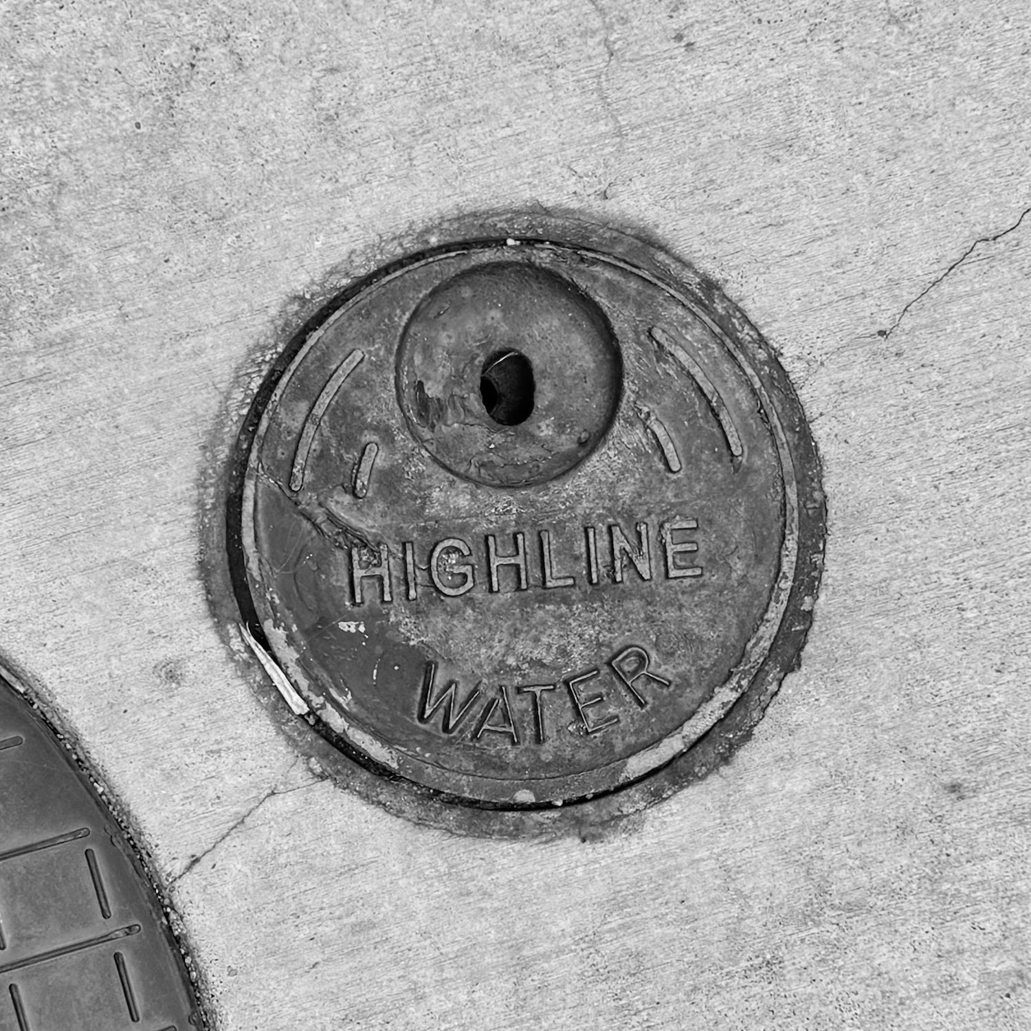 black and white image of a utility cover