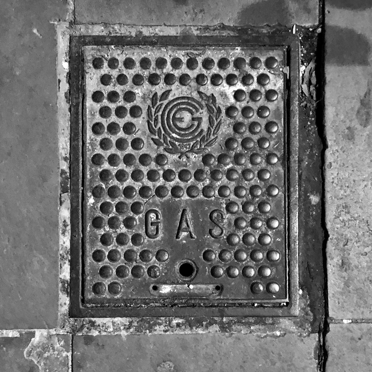 black and white image of a utility cover