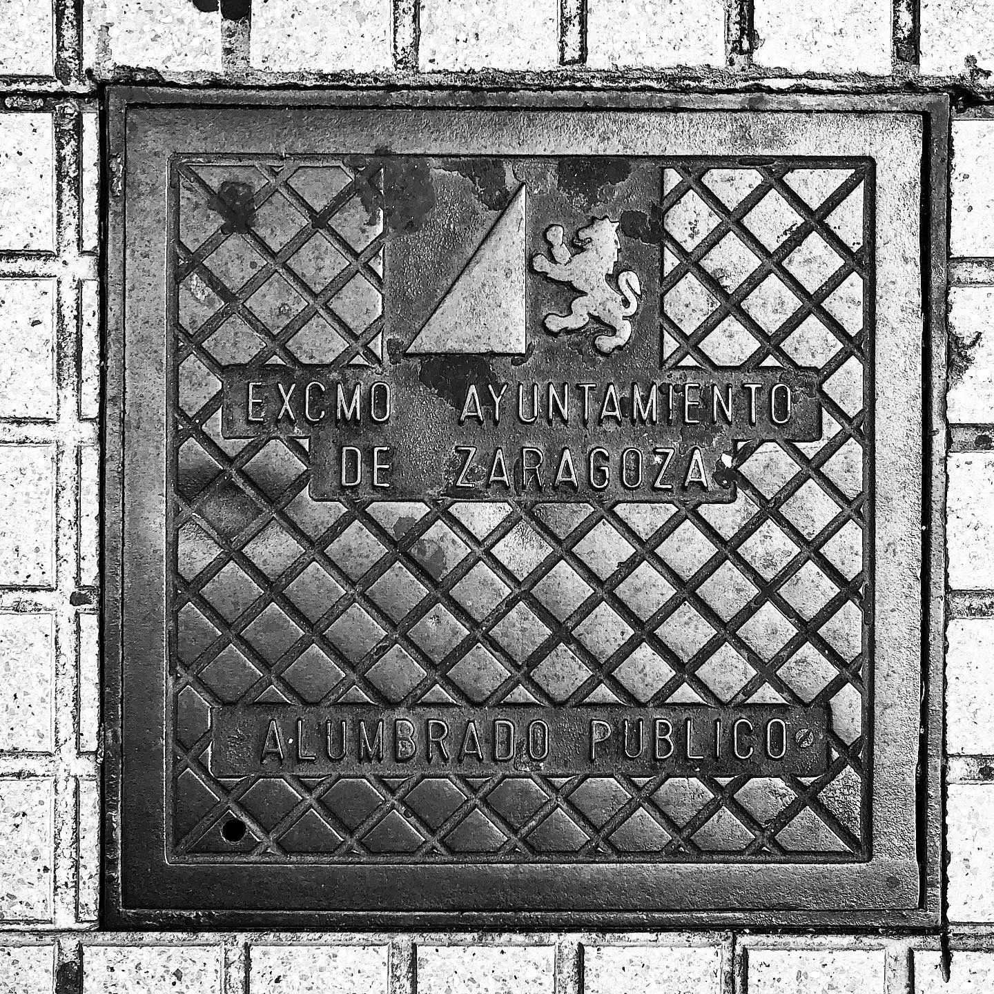 black and white image of a utility cover