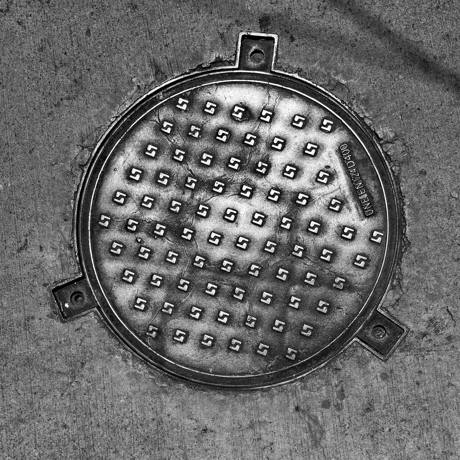 black and white image of a utility cover