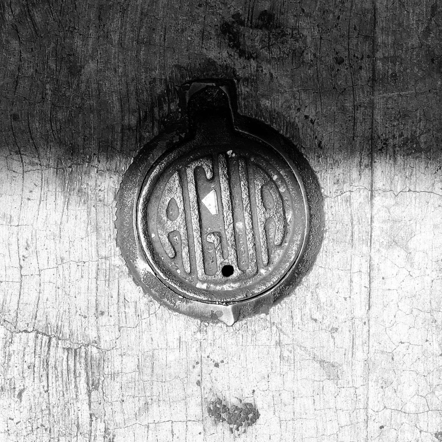 black and white image of a utility cover