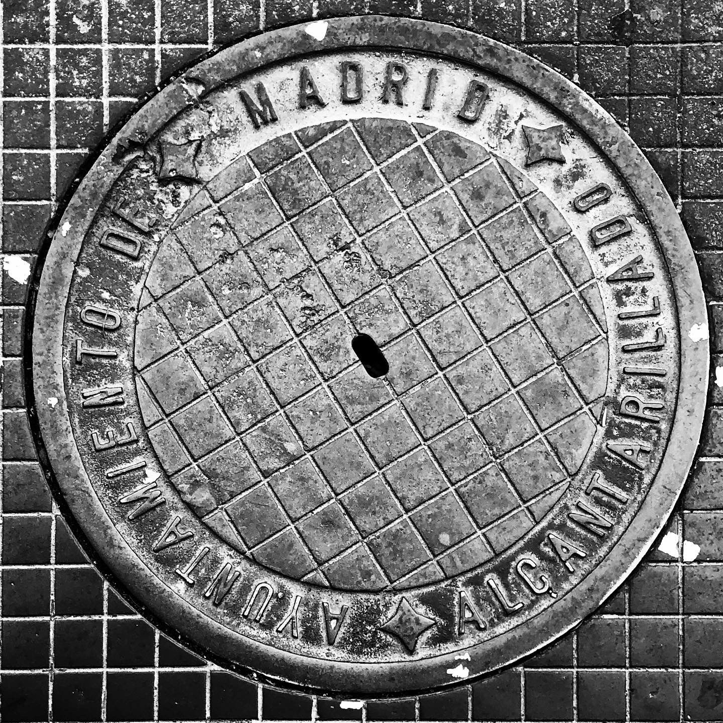 black and white image of a utility cover