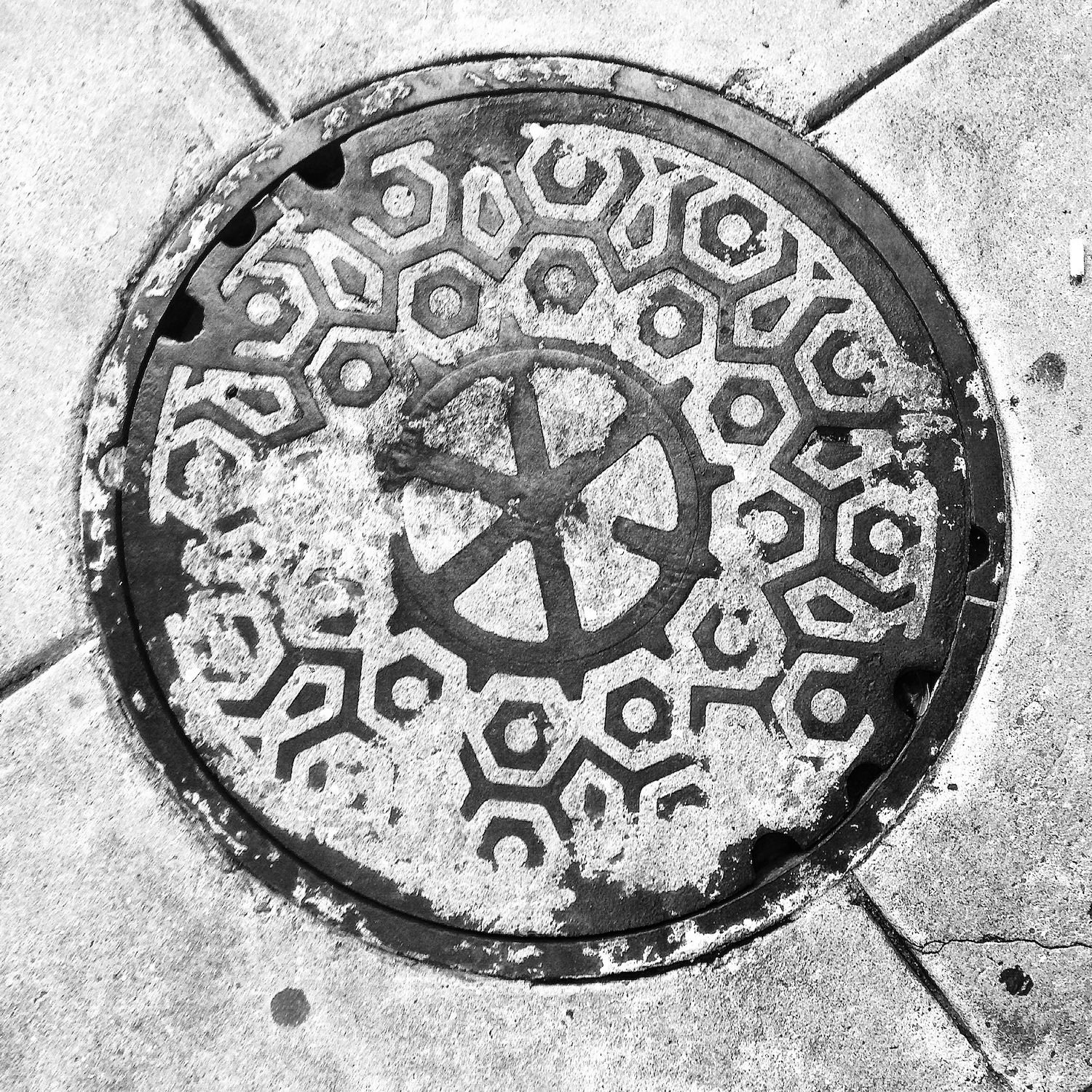 black and white image of a utility cover