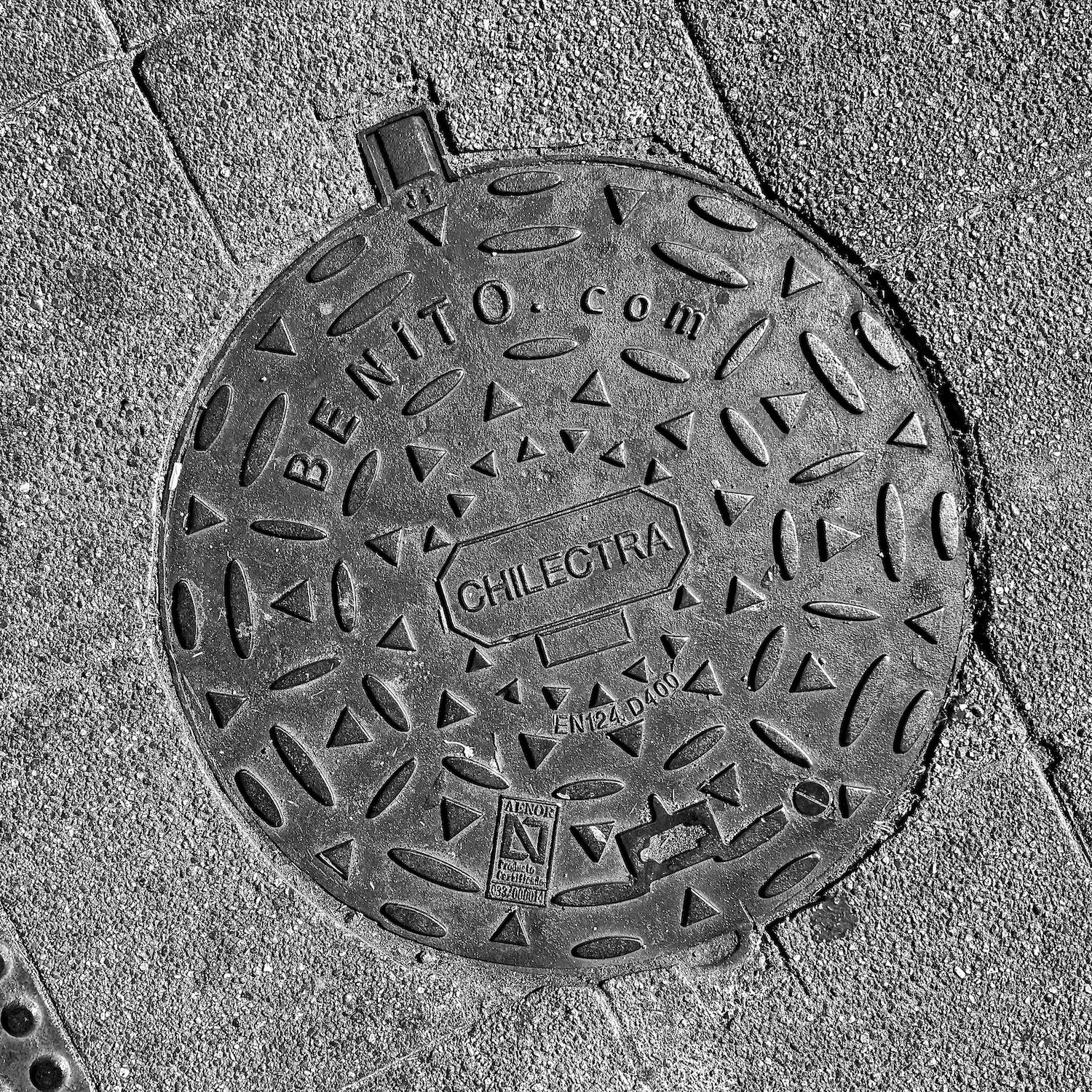 black and white image of a utility cover