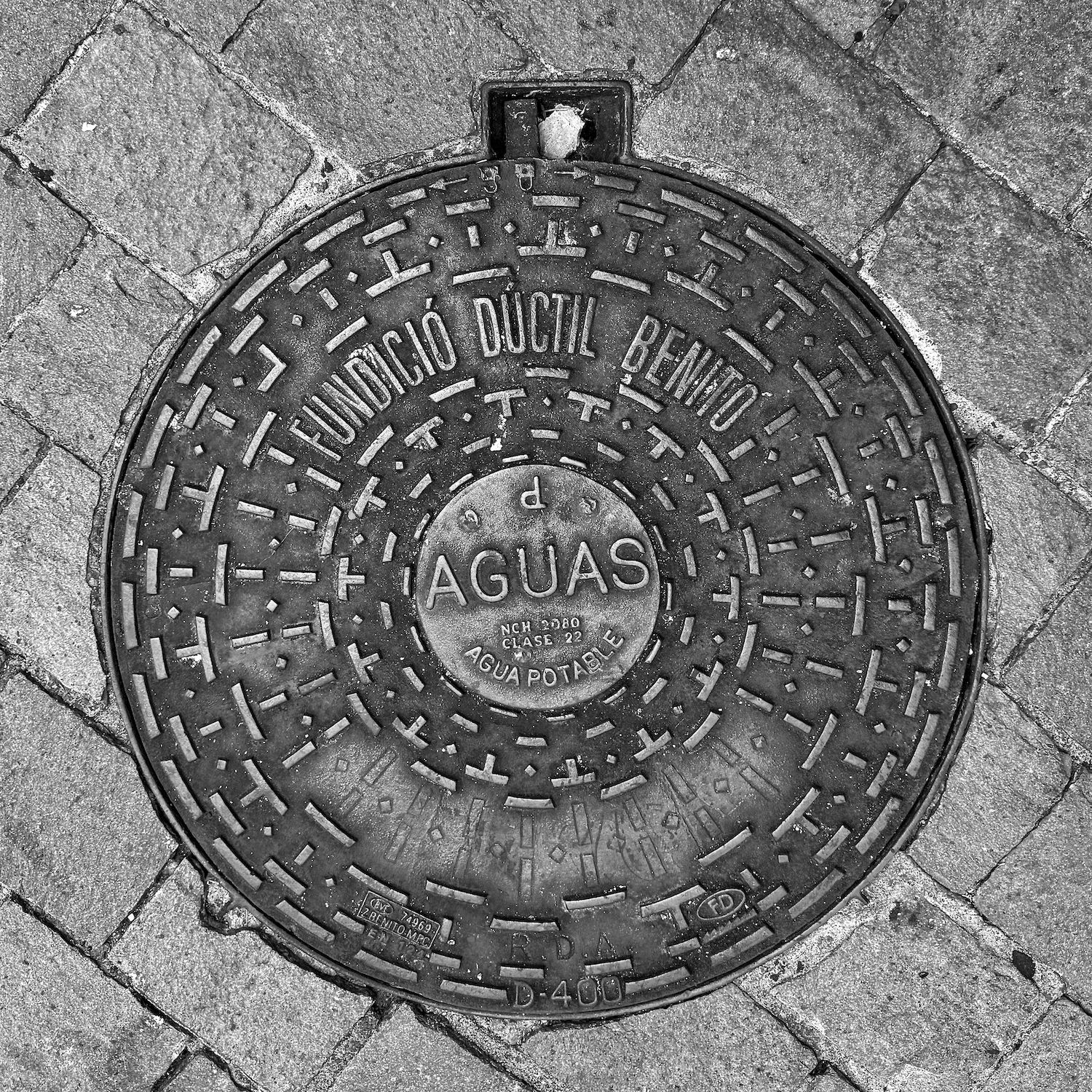 black and white image of a utility cover