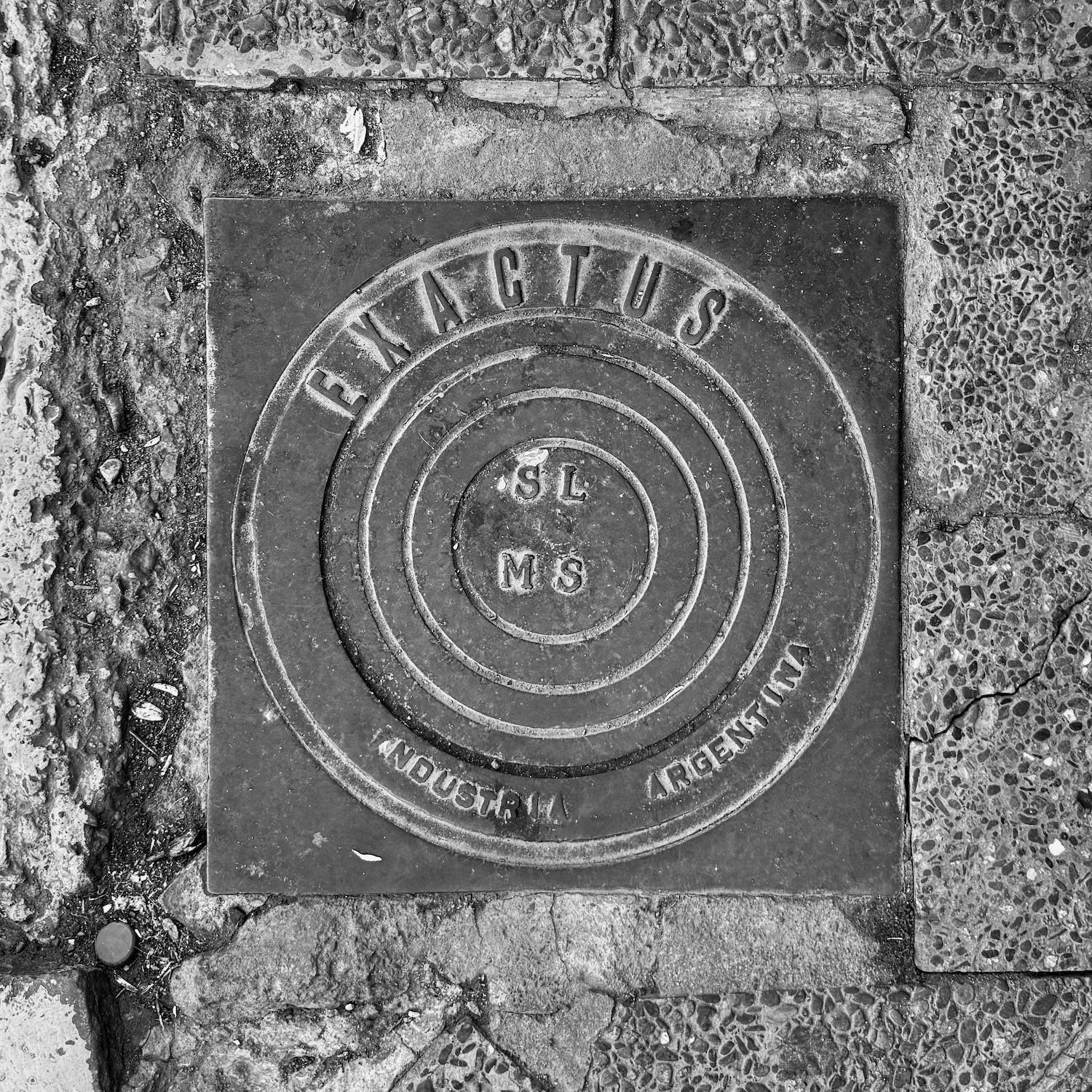 black and white image of a utility cover