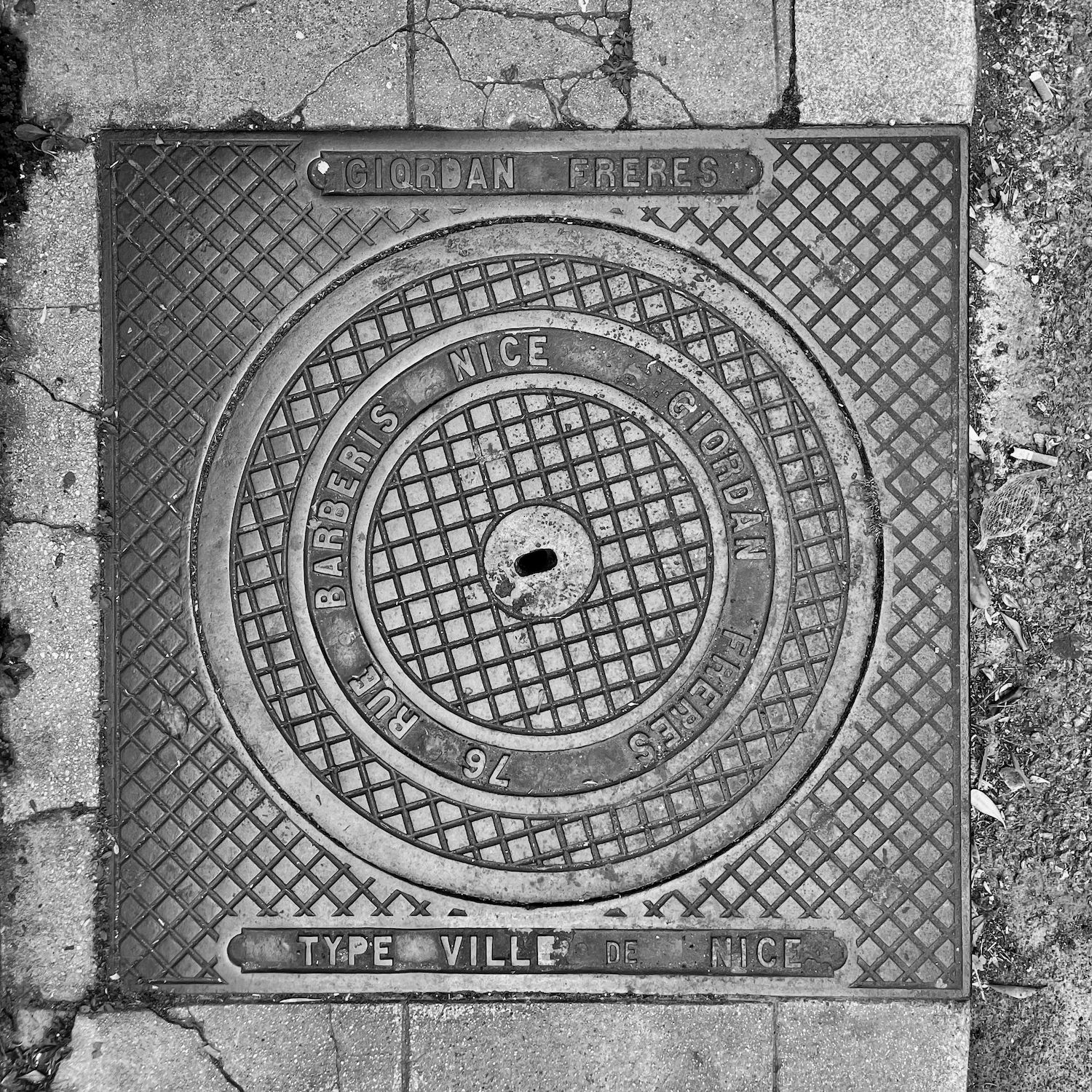 black and white image of a utility cover