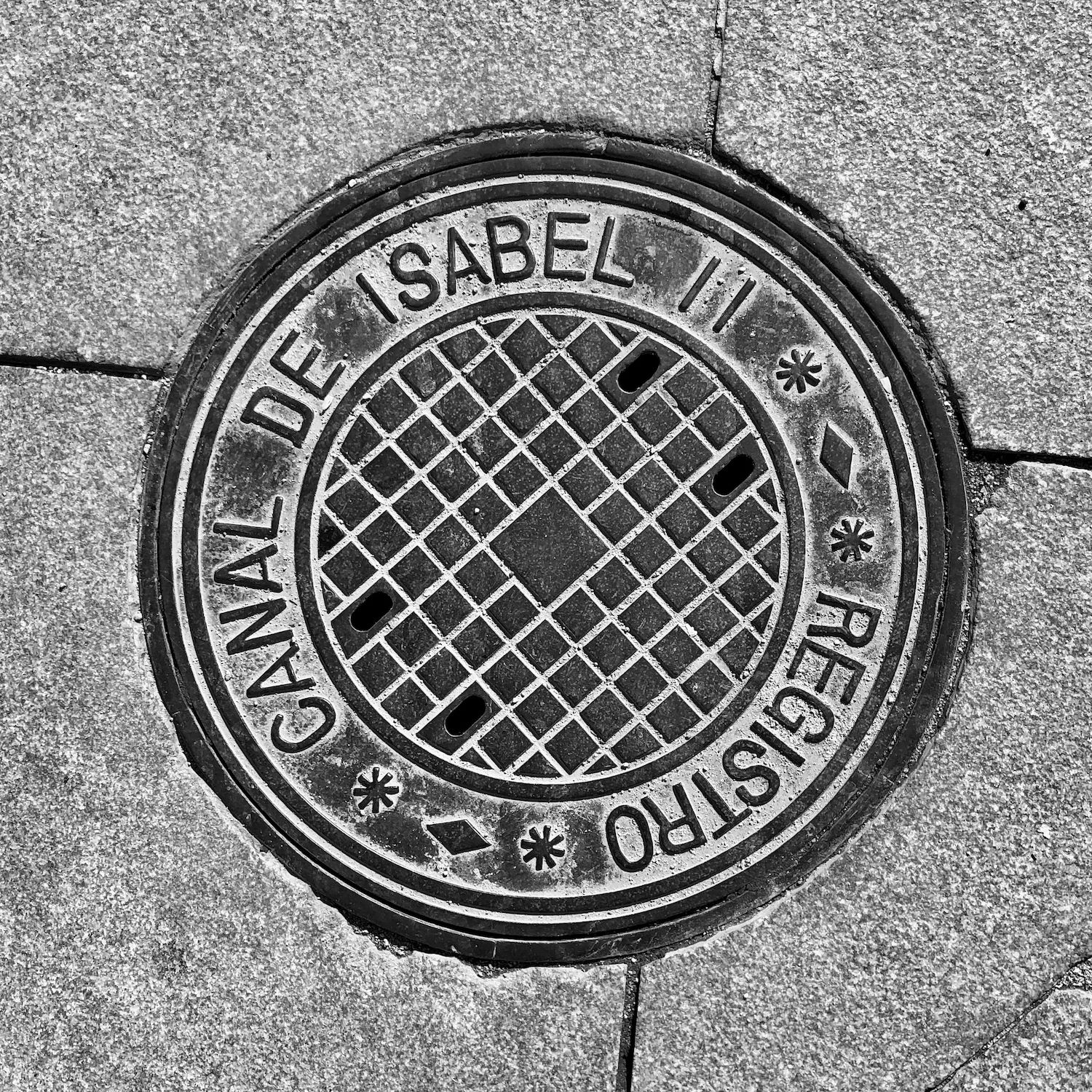 black and white image of a utility cover