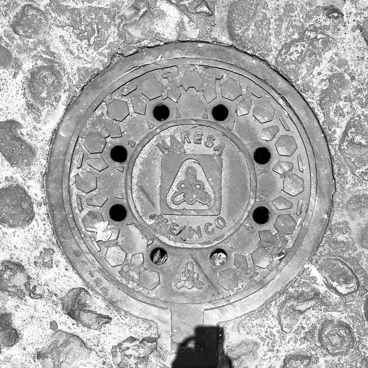 black and white image of a utility cover
