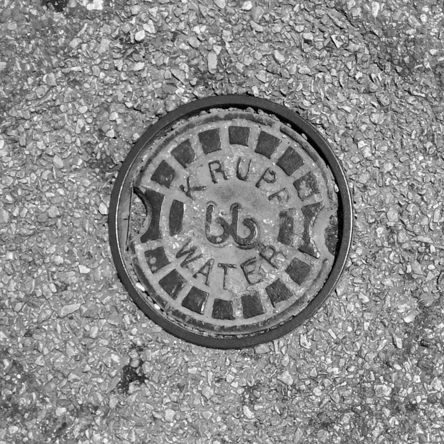 black and white image of a utility cover
