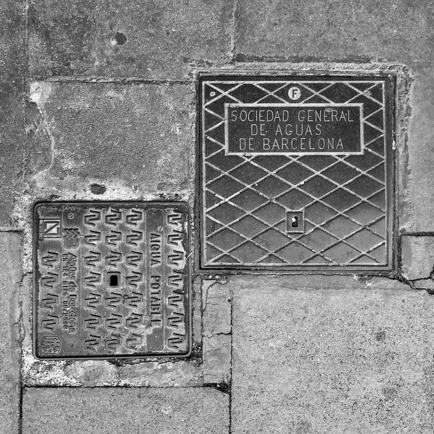 black and white image of a utility cover