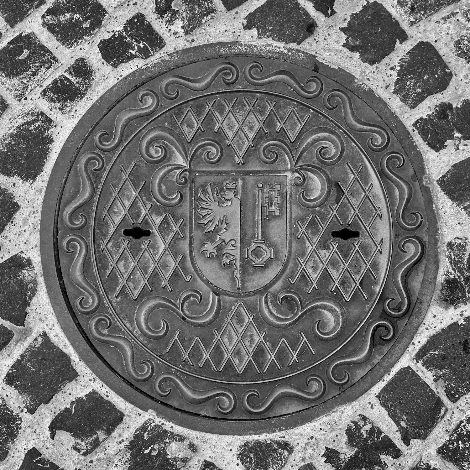black and white image of a utility cover