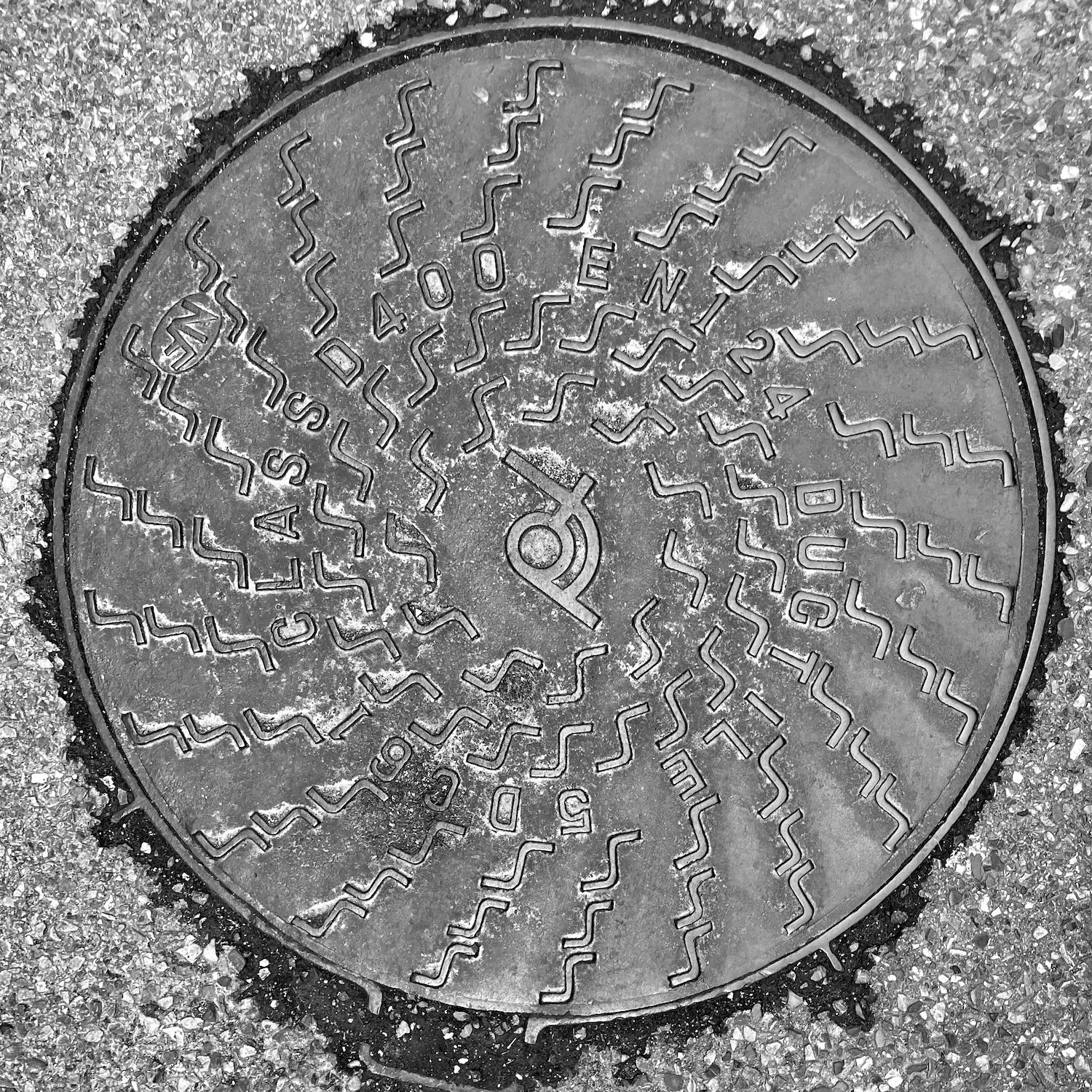 black and white image of a utility cover