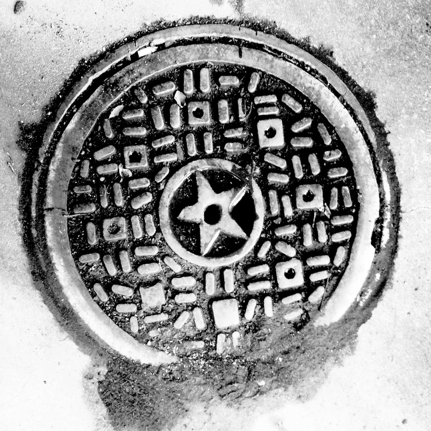 black and white image of a utility cover