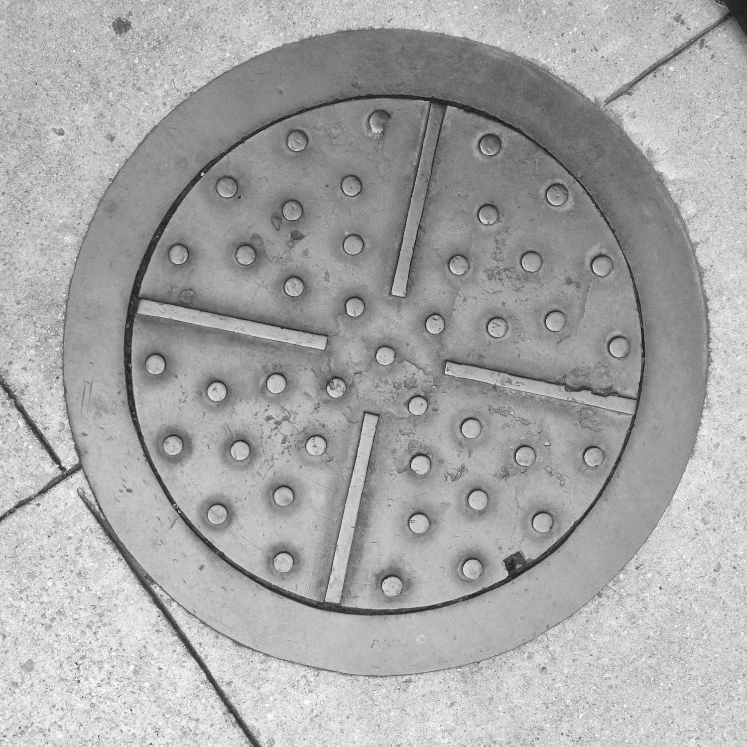 black and white image of a utility cover
