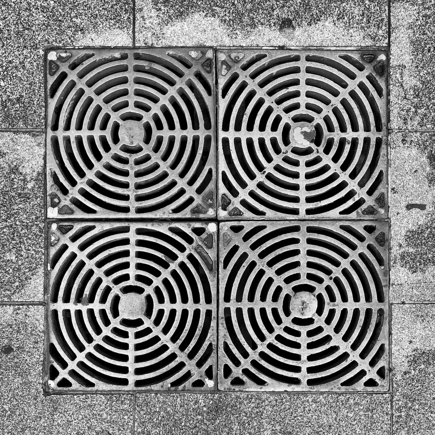 black and white image of a utility cover