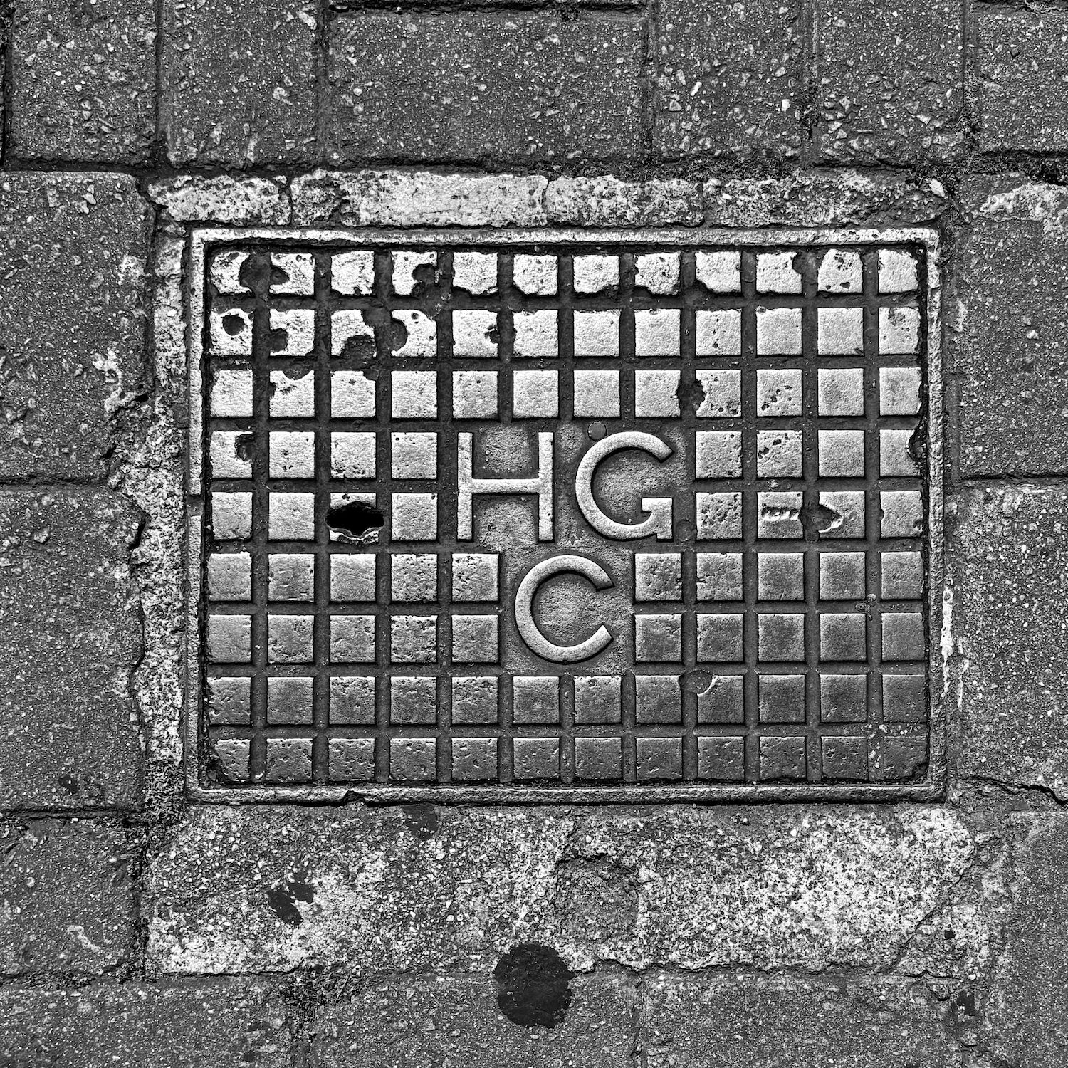 black and white image of a utility cover