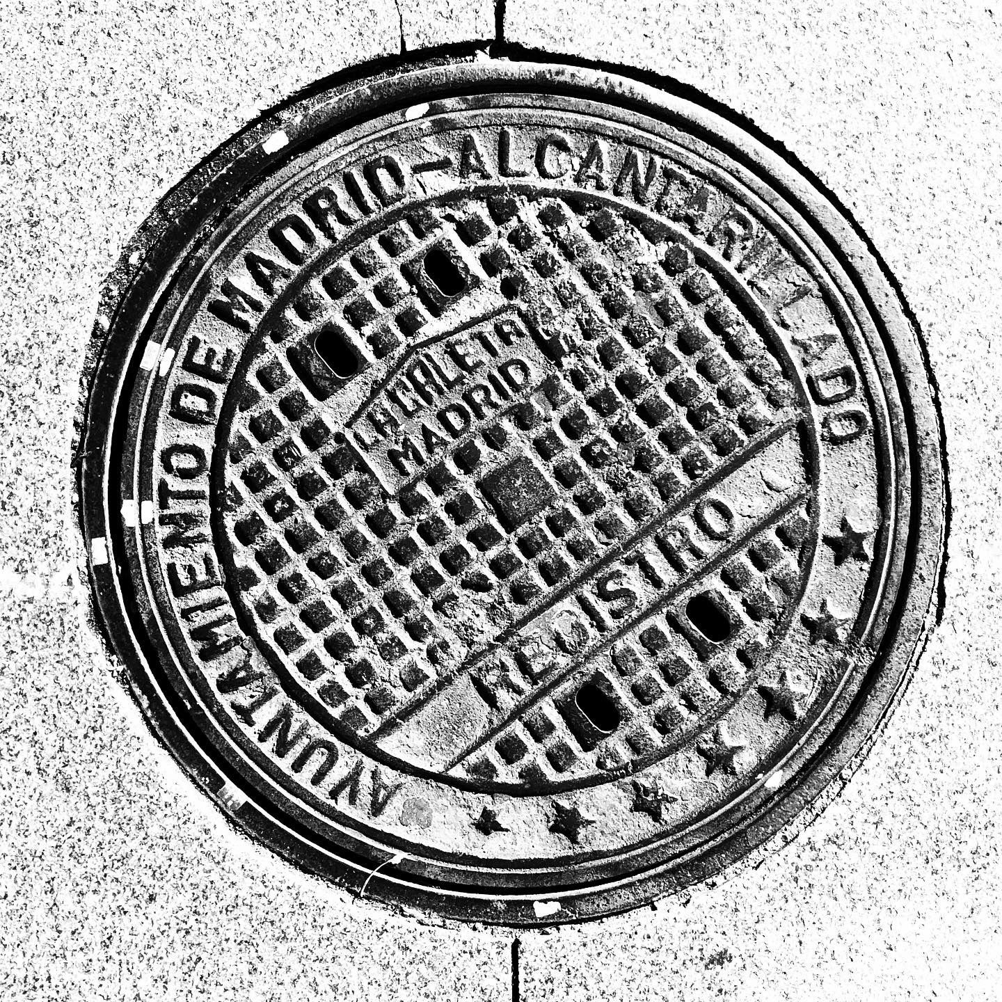 black and white image of a utility cover