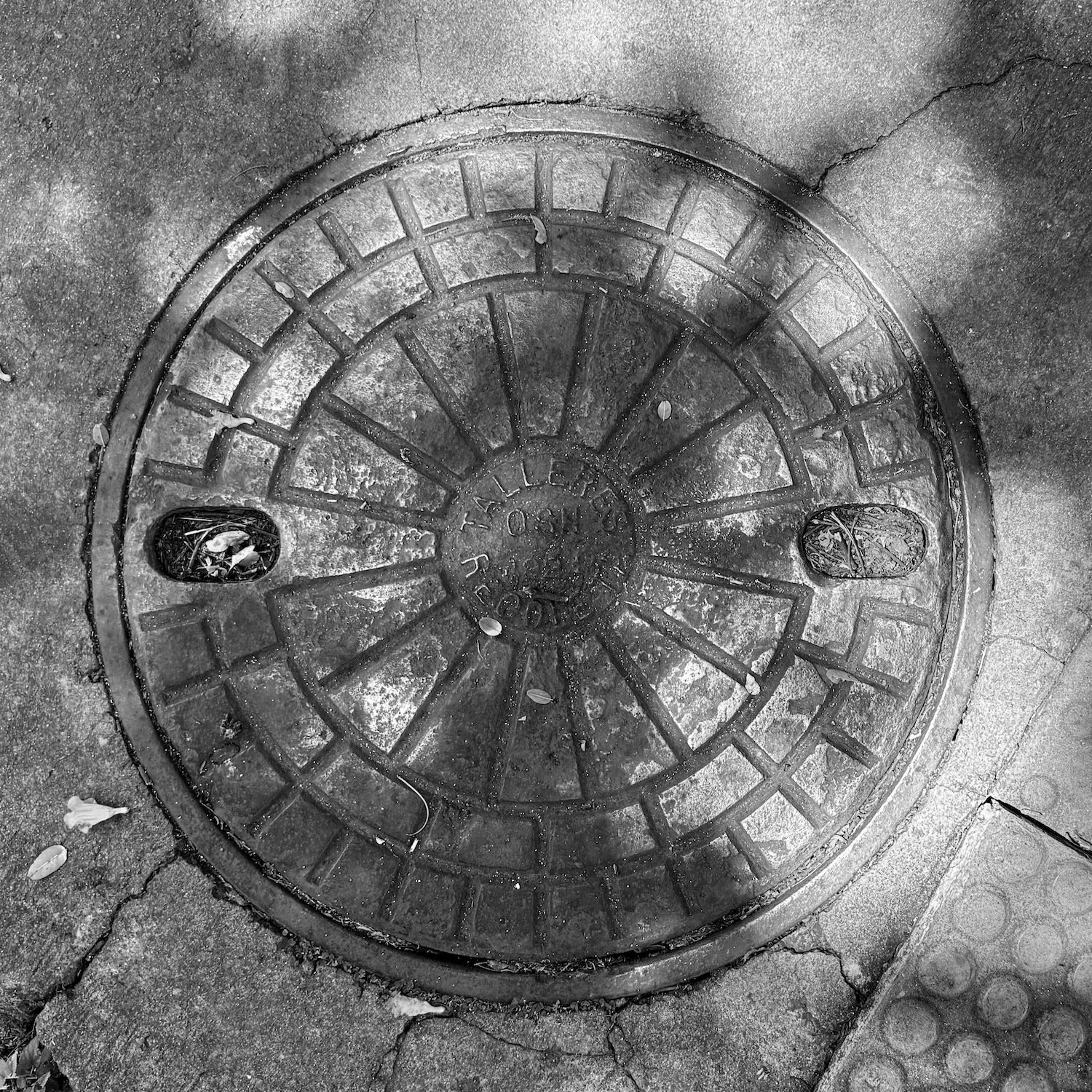 black and white image of a utility cover