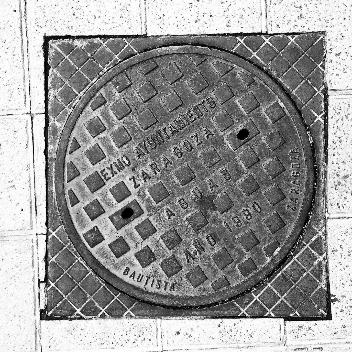 black and white image of a utility cover