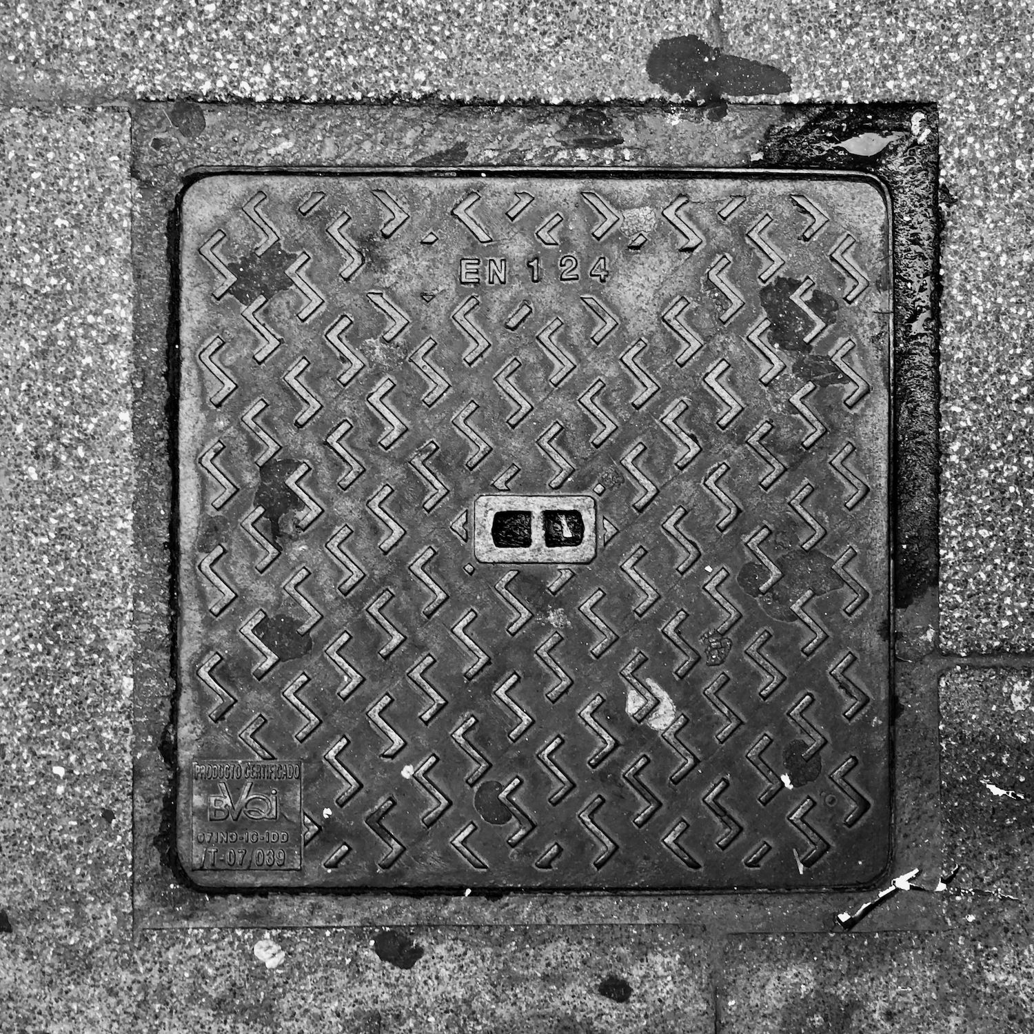 black and white image of a utility cover