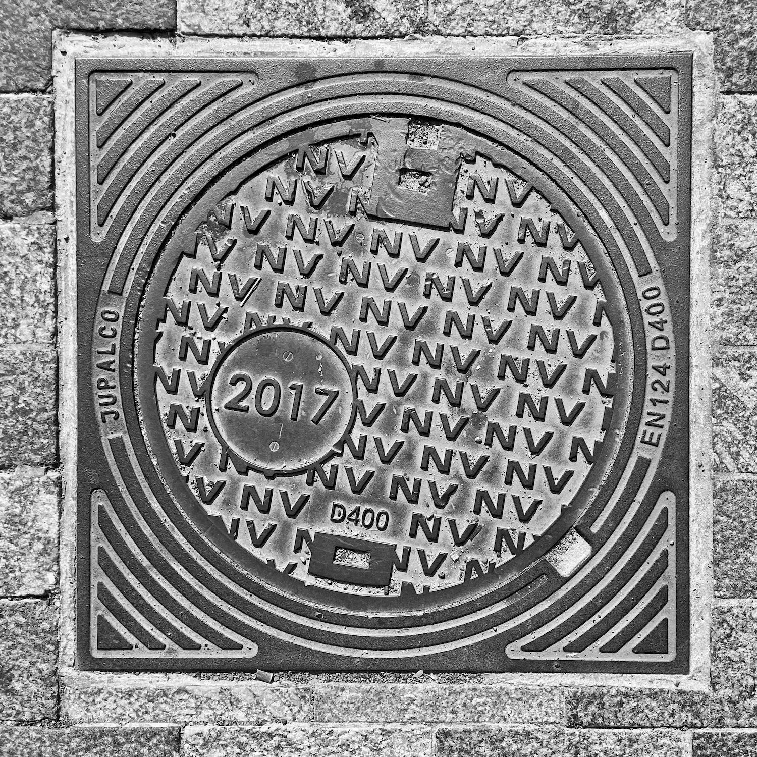 black and white image of a utility cover