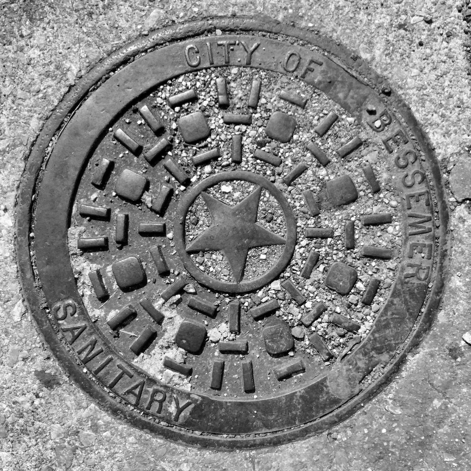 black and white image of a utility cover