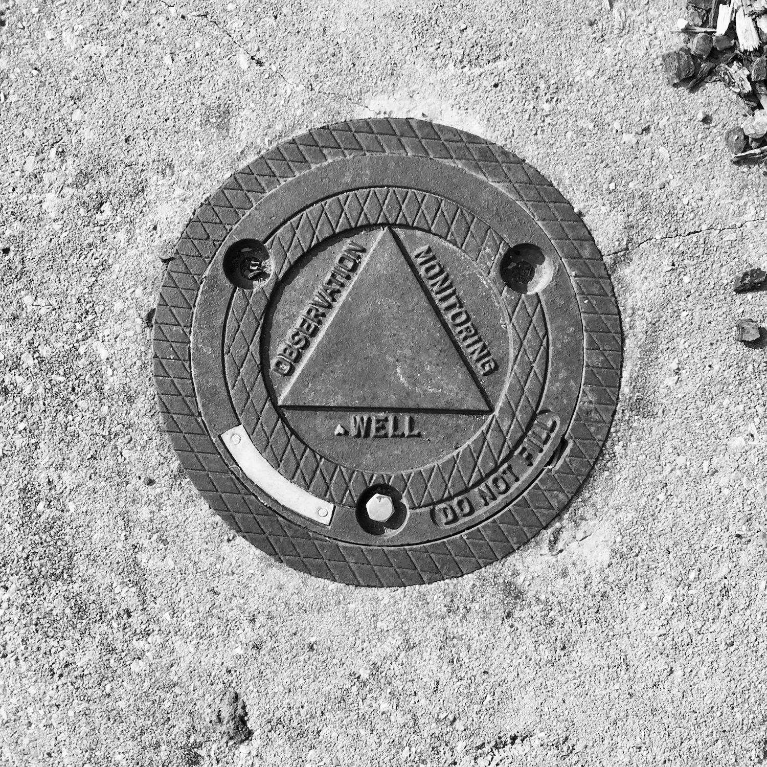 black and white image of a utility cover