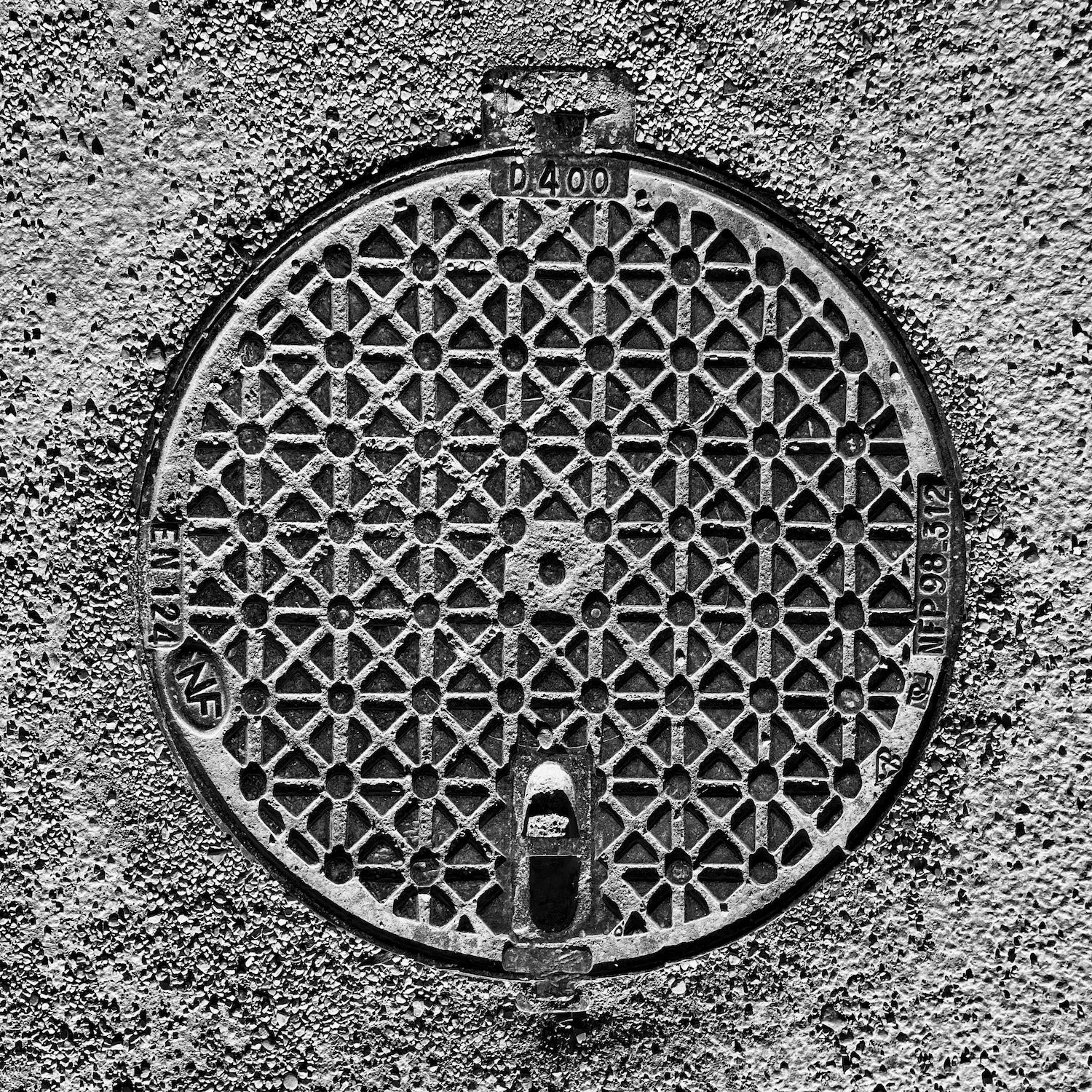 black and white image of a utility cover