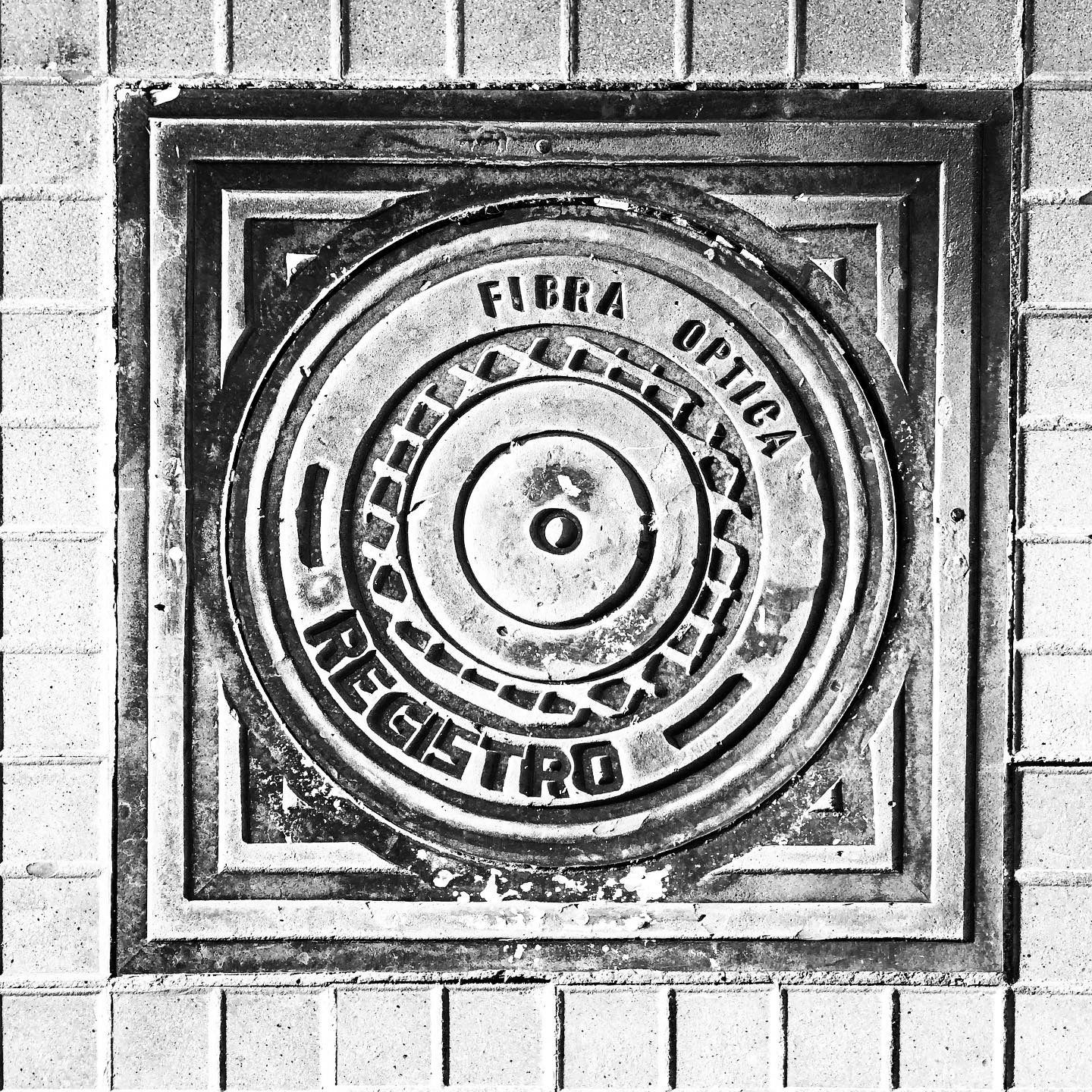 black and white image of a utility cover