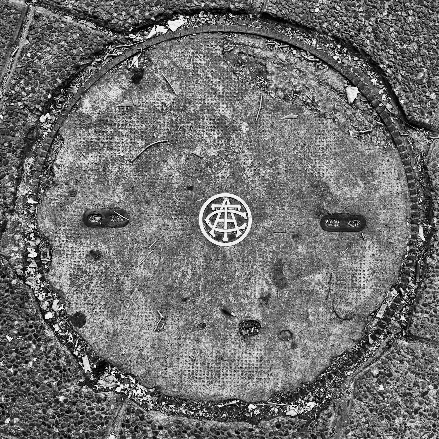 black and white image of a utility cover