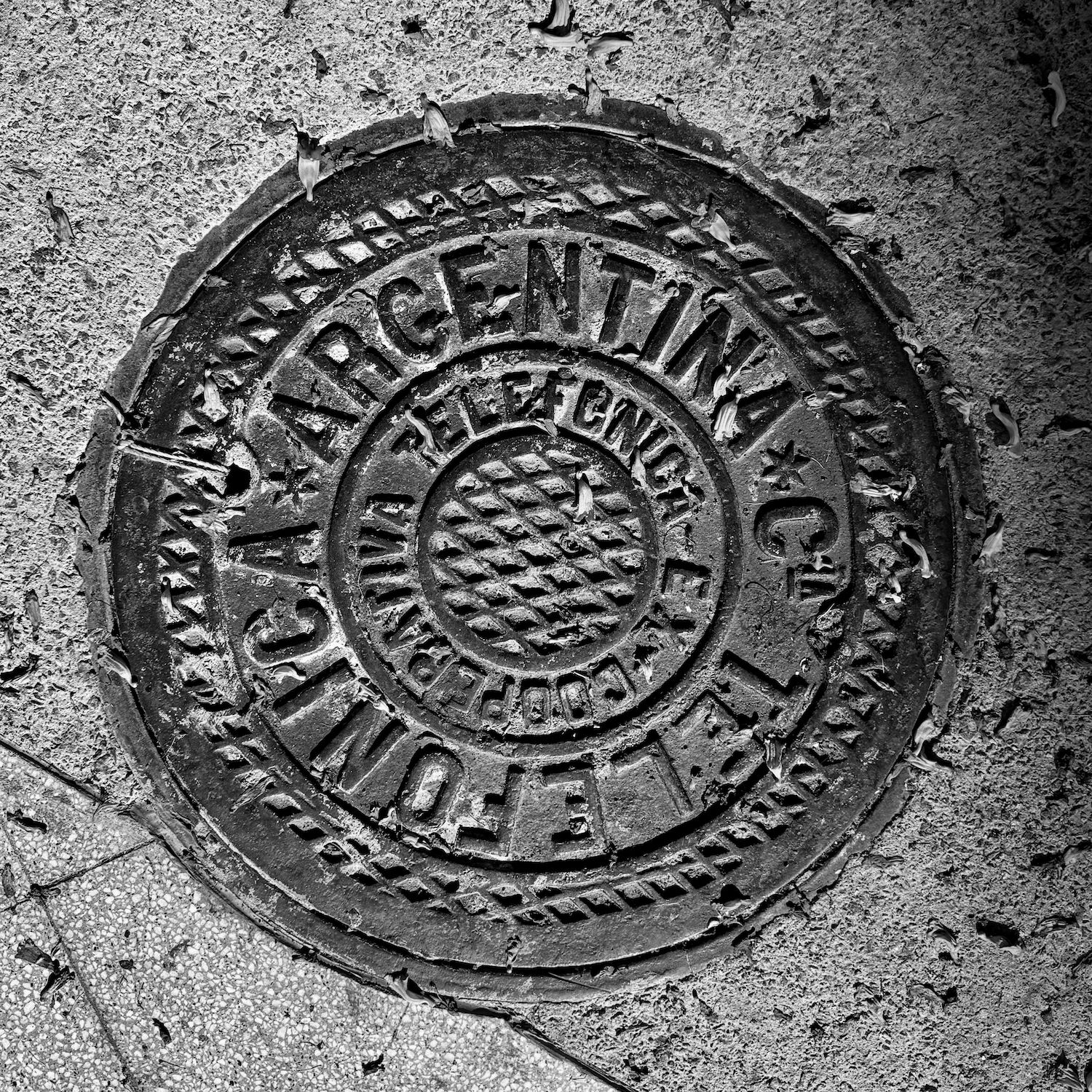 black and white image of a utility cover