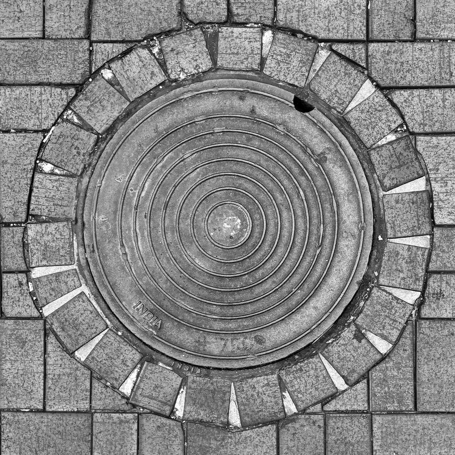 black and white image of a utility cover