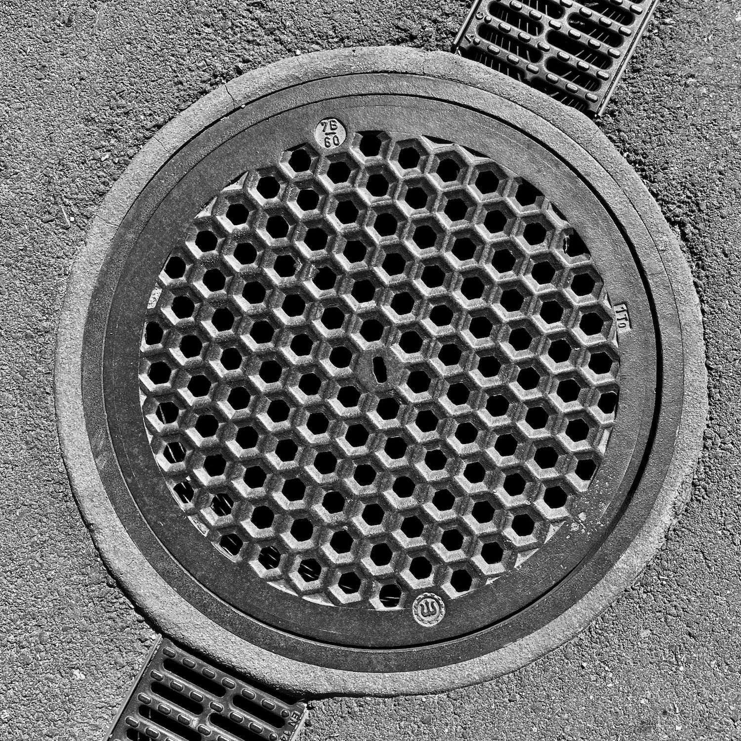 black and white image of a utility cover