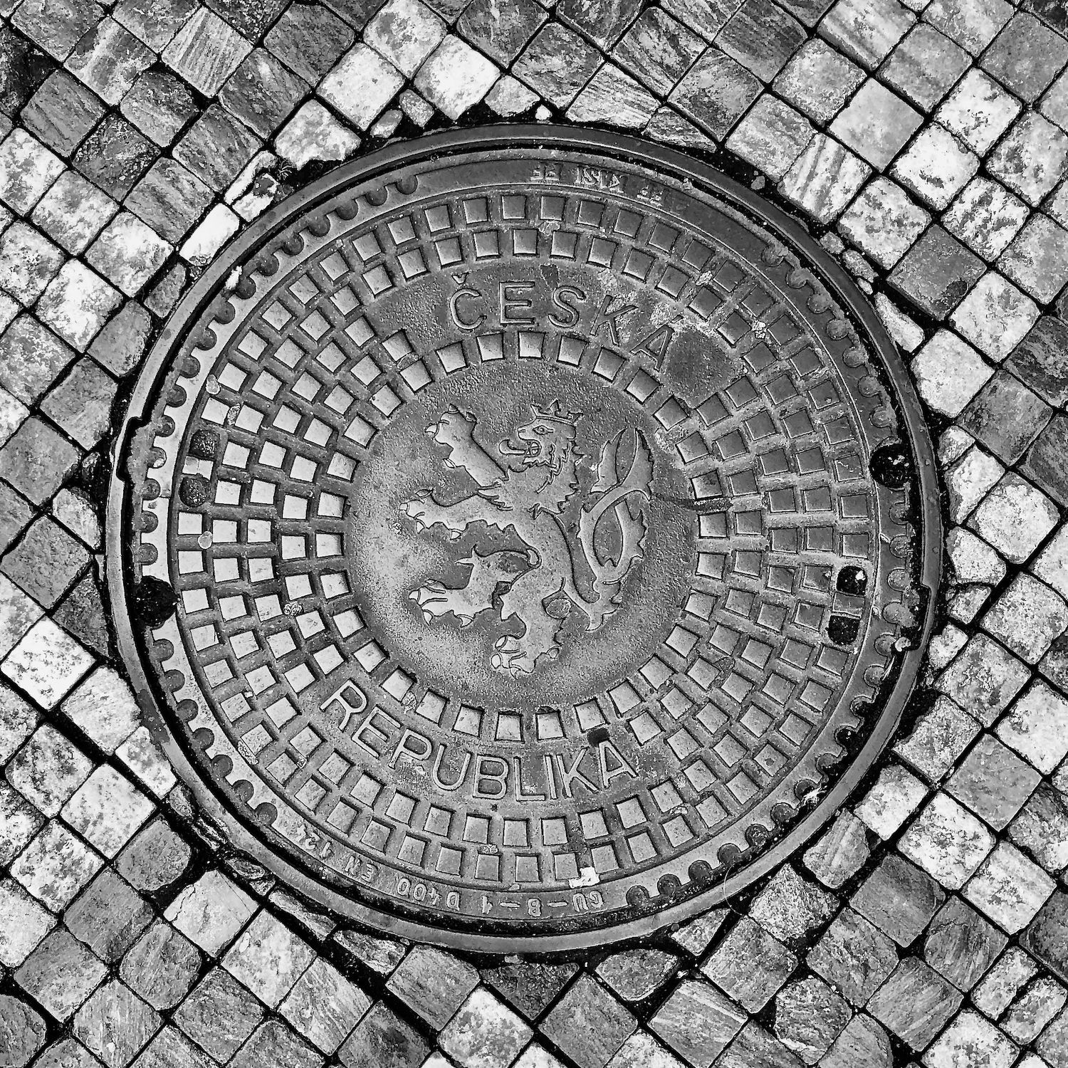 black and white image of a utility cover