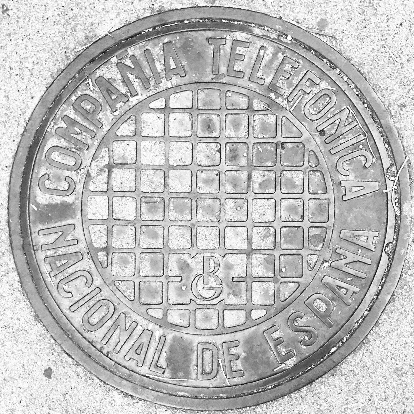 black and white image of a utility cover