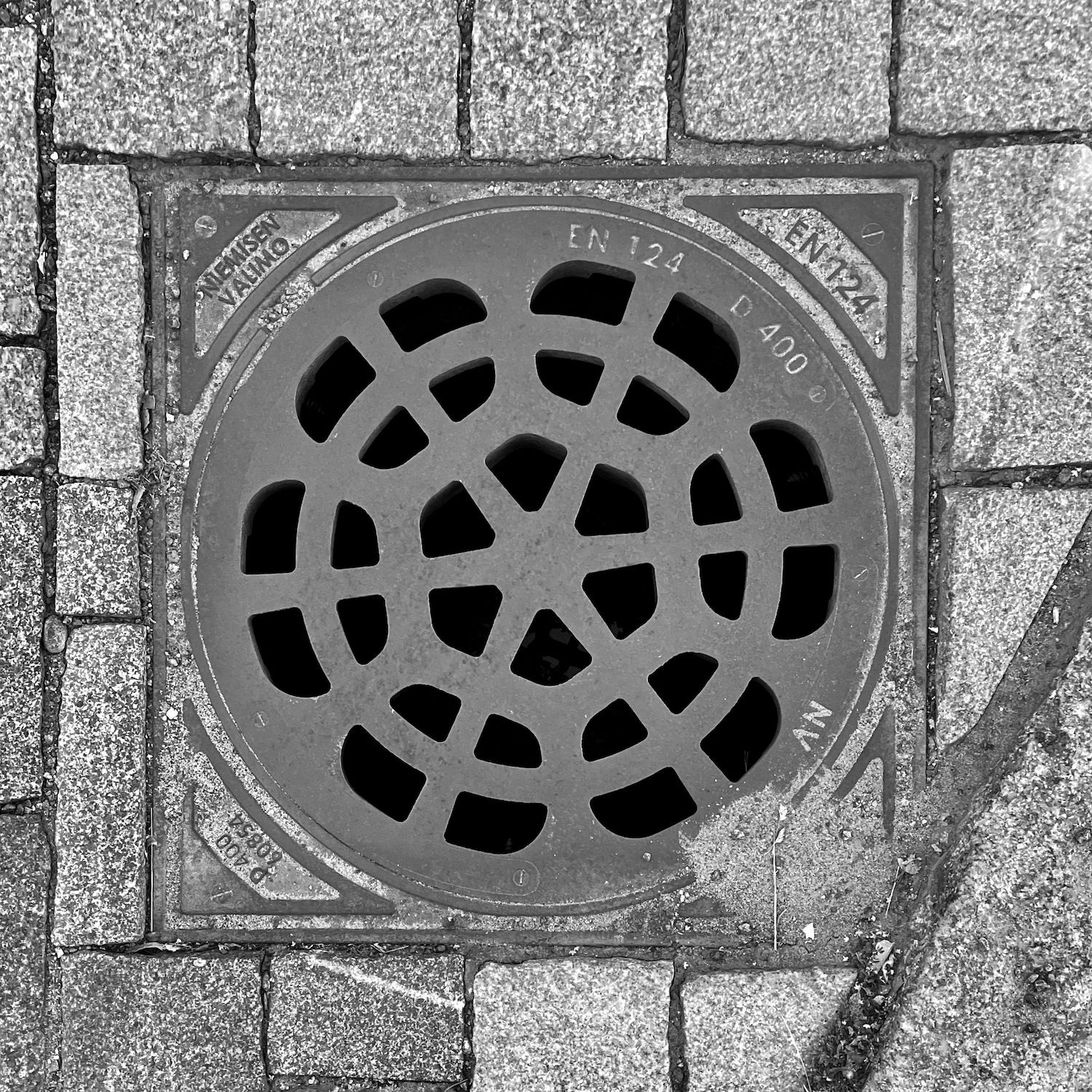 black and white image of a utility cover