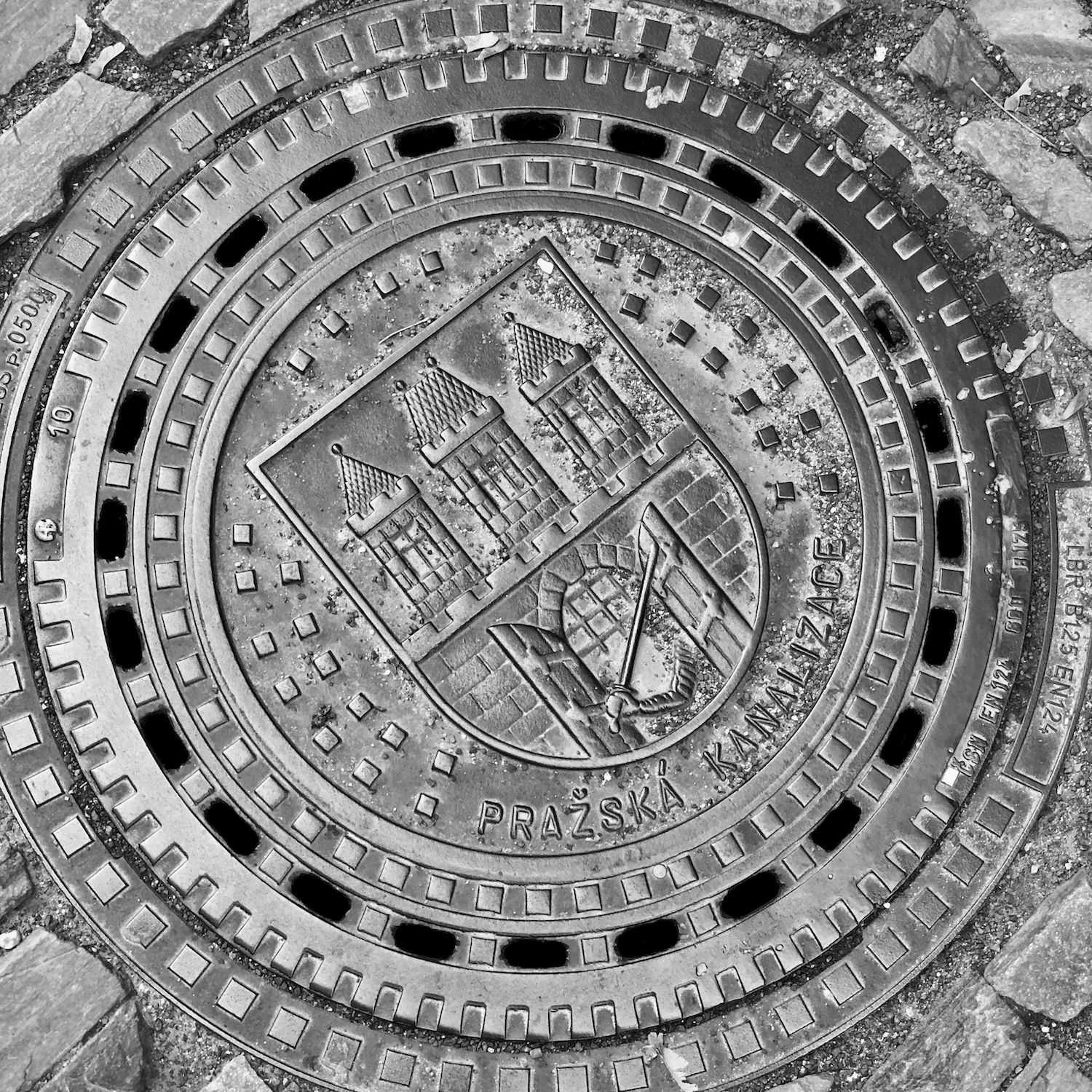 black and white image of a utility cover