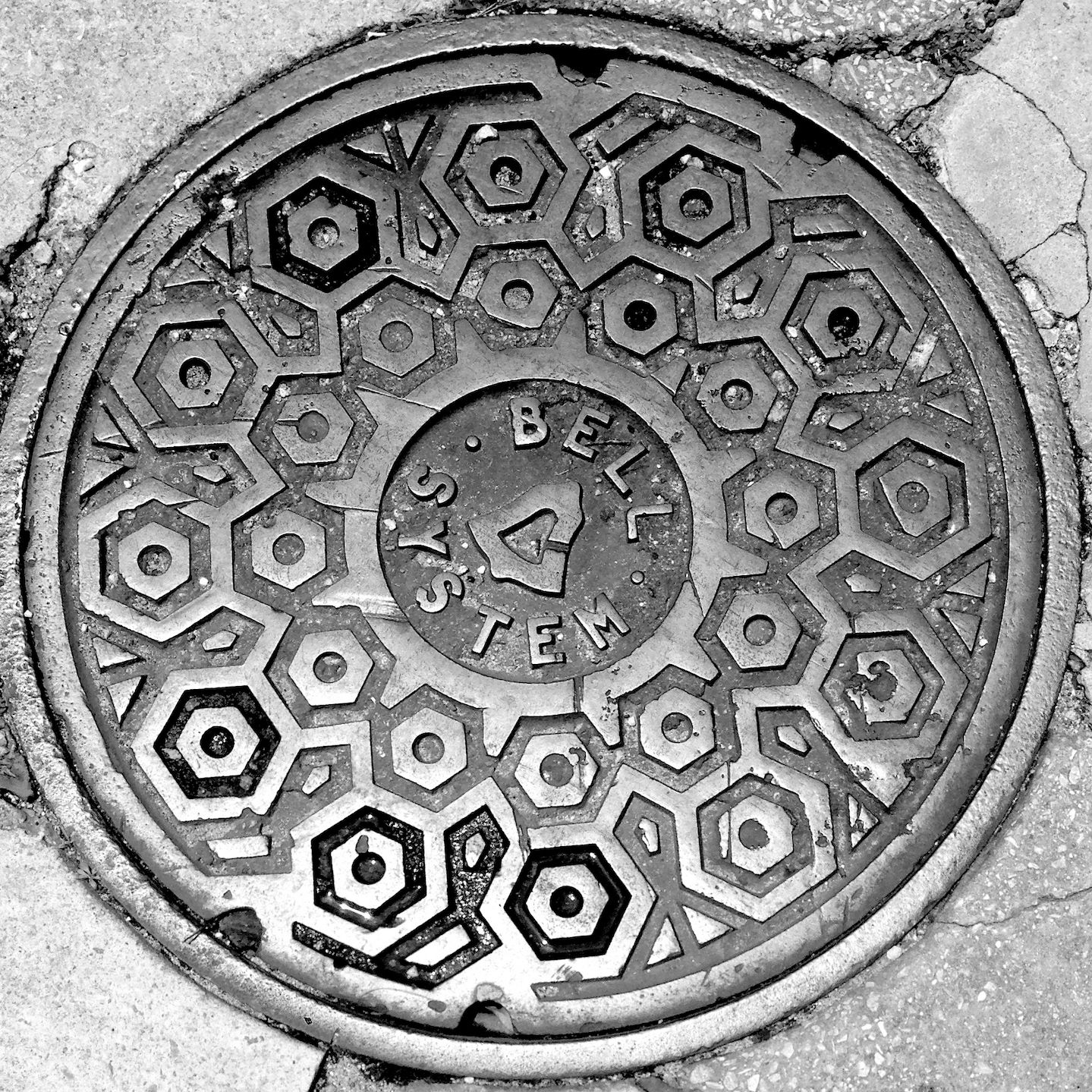 black and white image of a utility cover