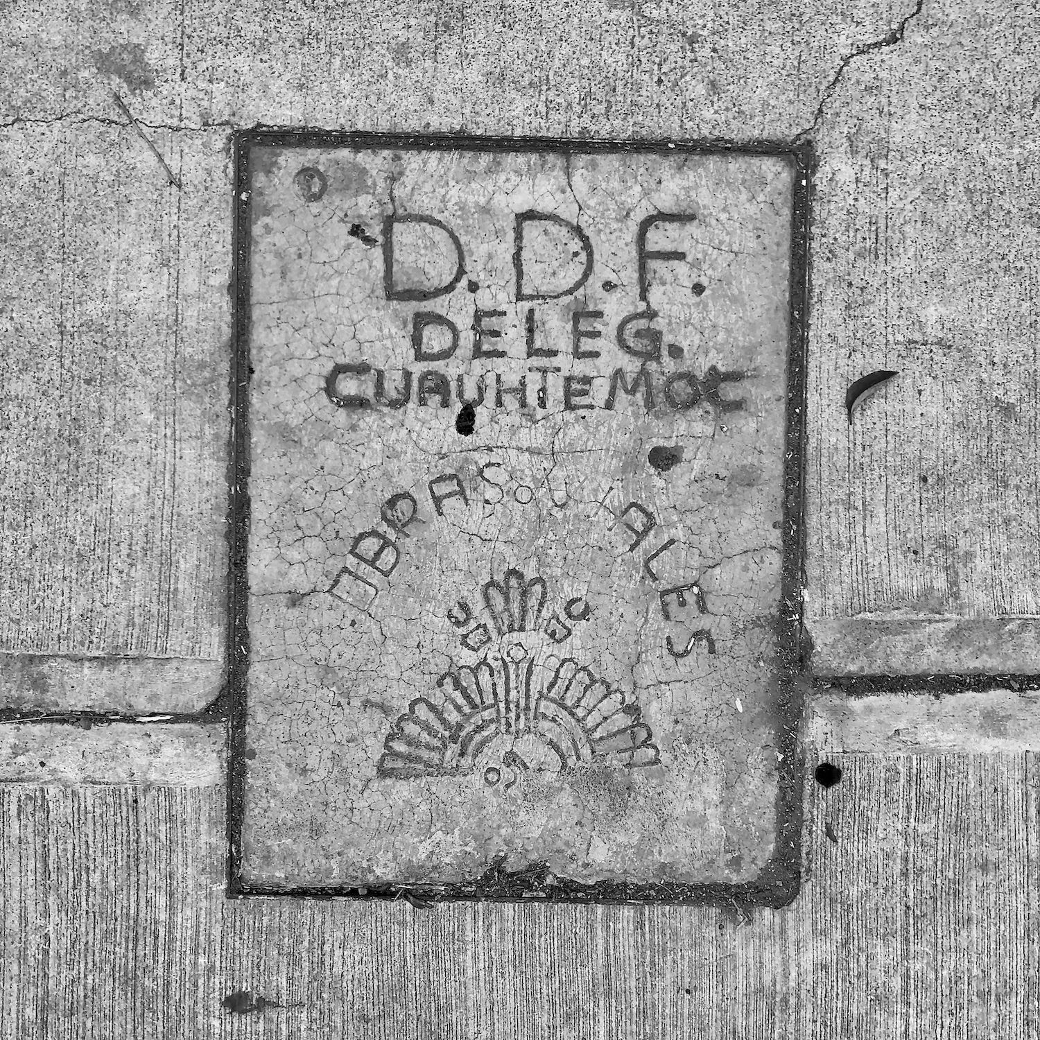 black and white image of a utility cover