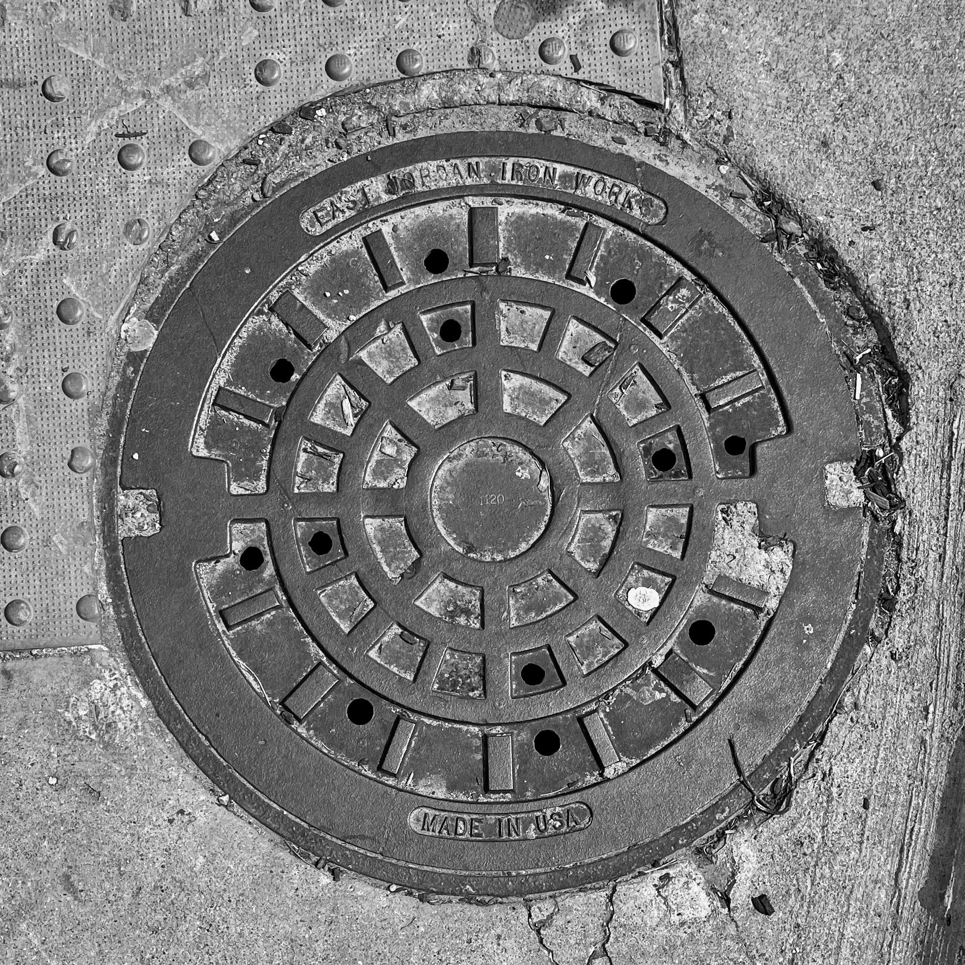 black and white image of a utility cover