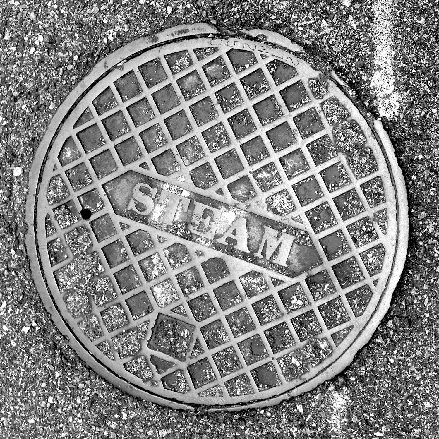 black and white image of a utility cover