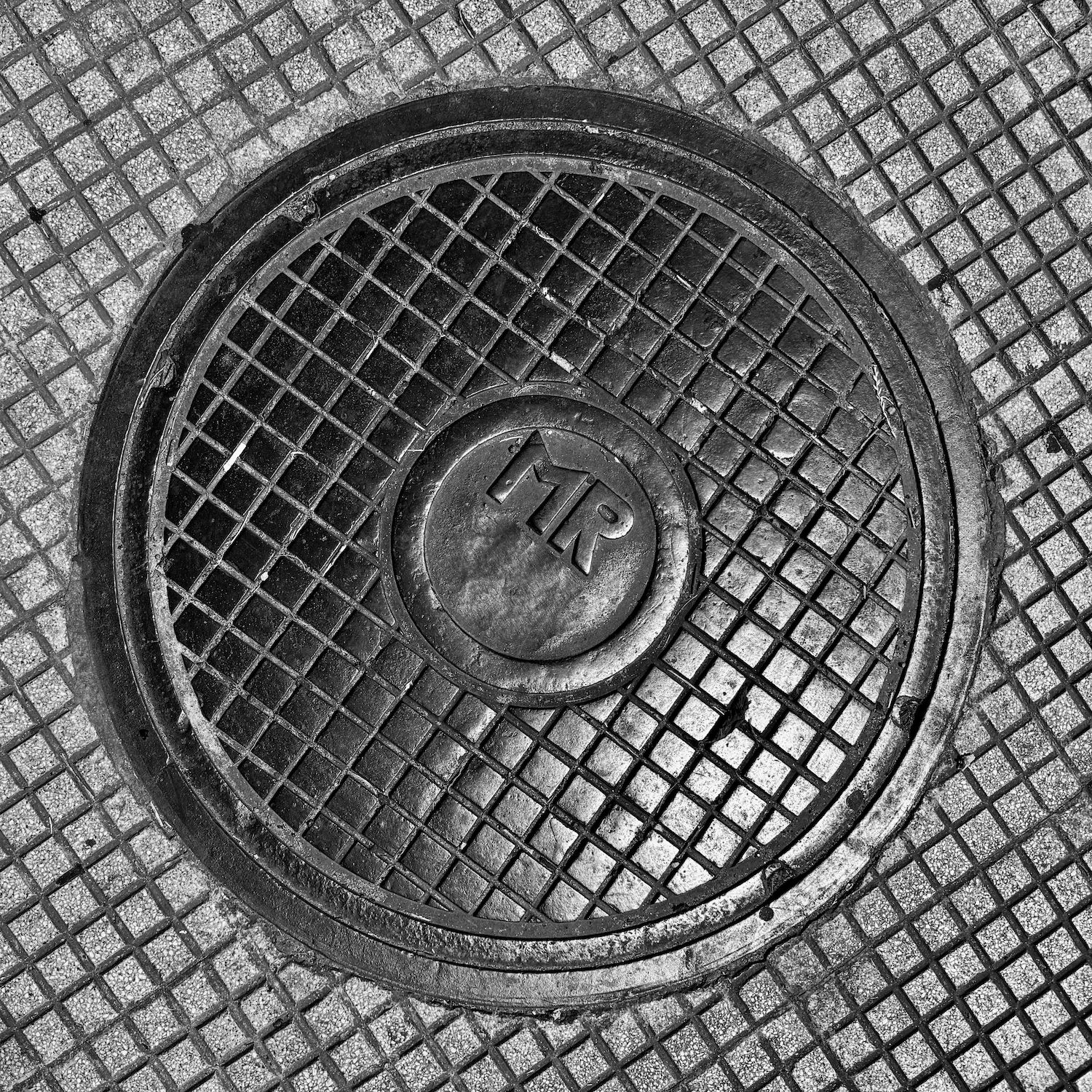 black and white image of a utility cover