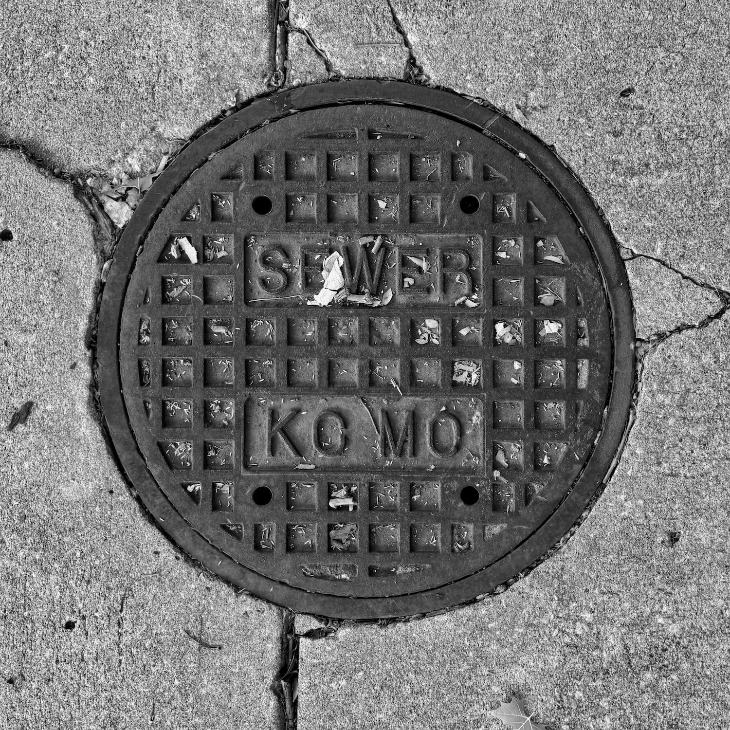 black and white image of a utility cover