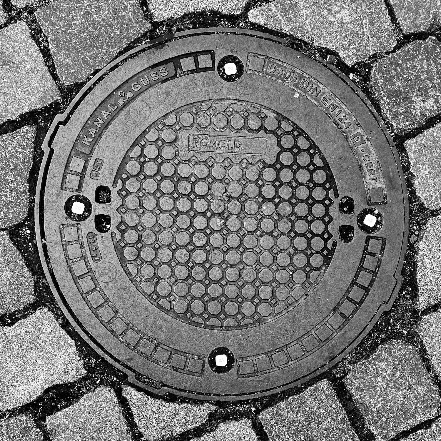 black and white image of a utility cover