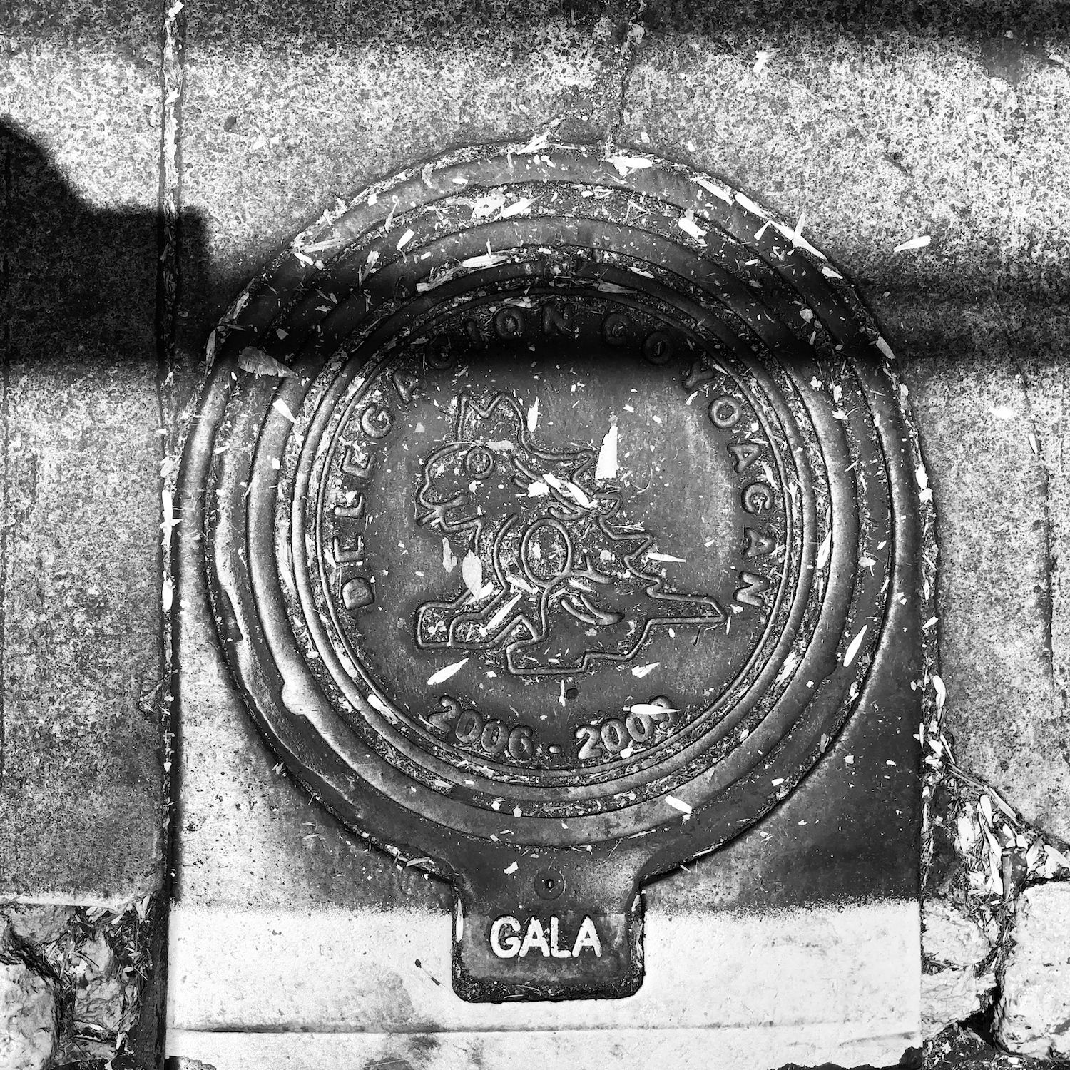black and white image of a utility cover