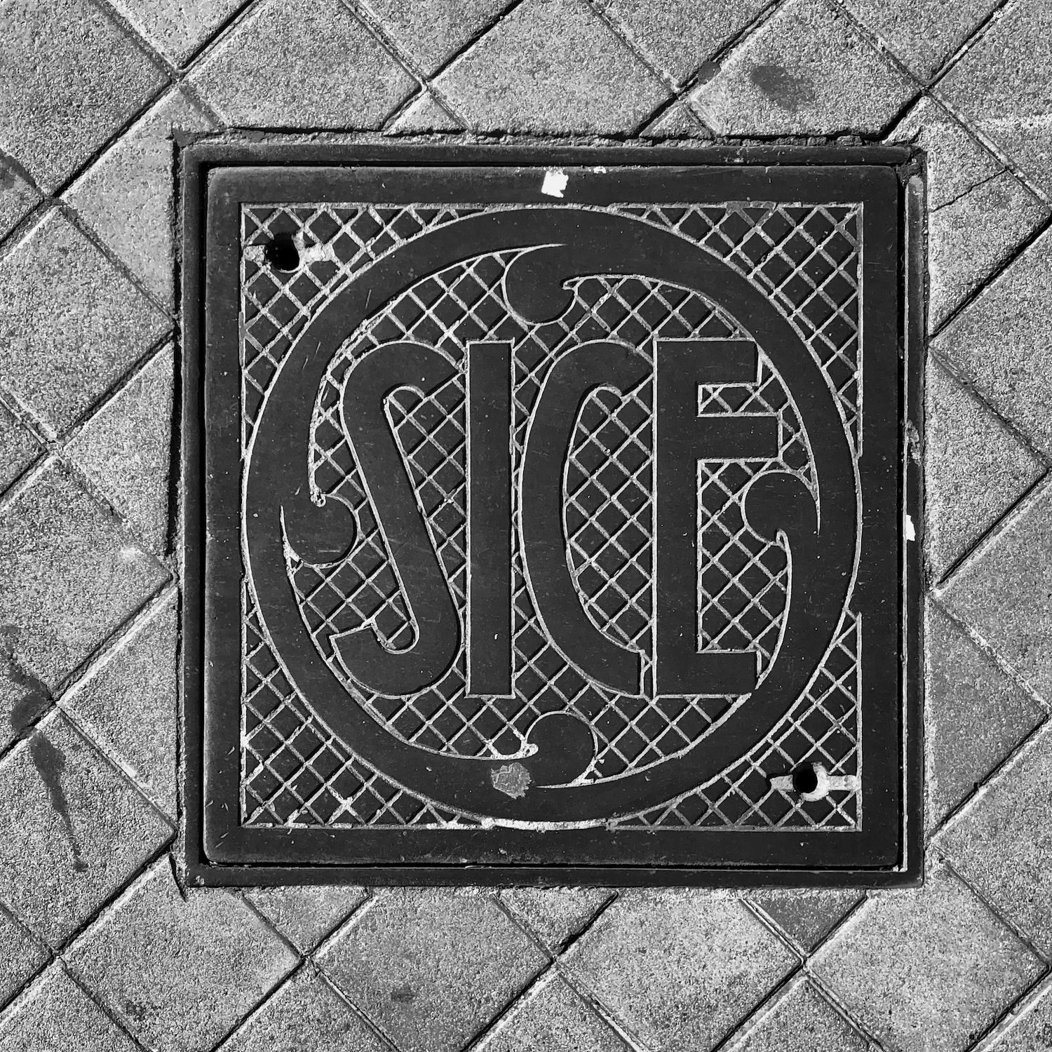 black and white image of a utility cover