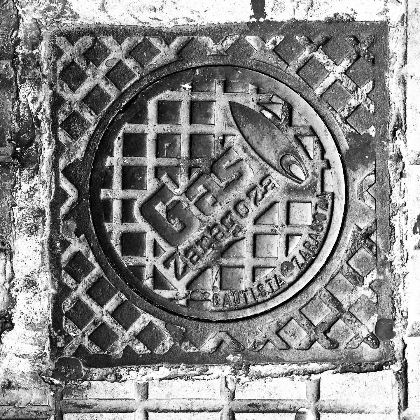 black and white image of a utility cover